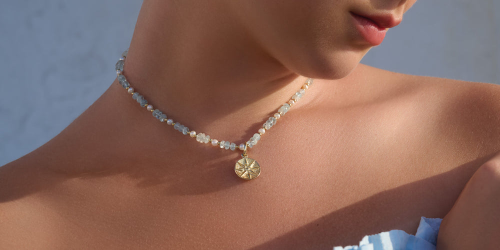 Model wears Cassandra Goad's Serena necklace with Star of Vergina medallion charm pendant.