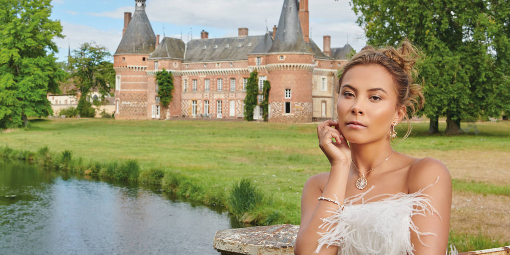 Model wearing Cassandra Goad jewellery posing in front of a French castle
