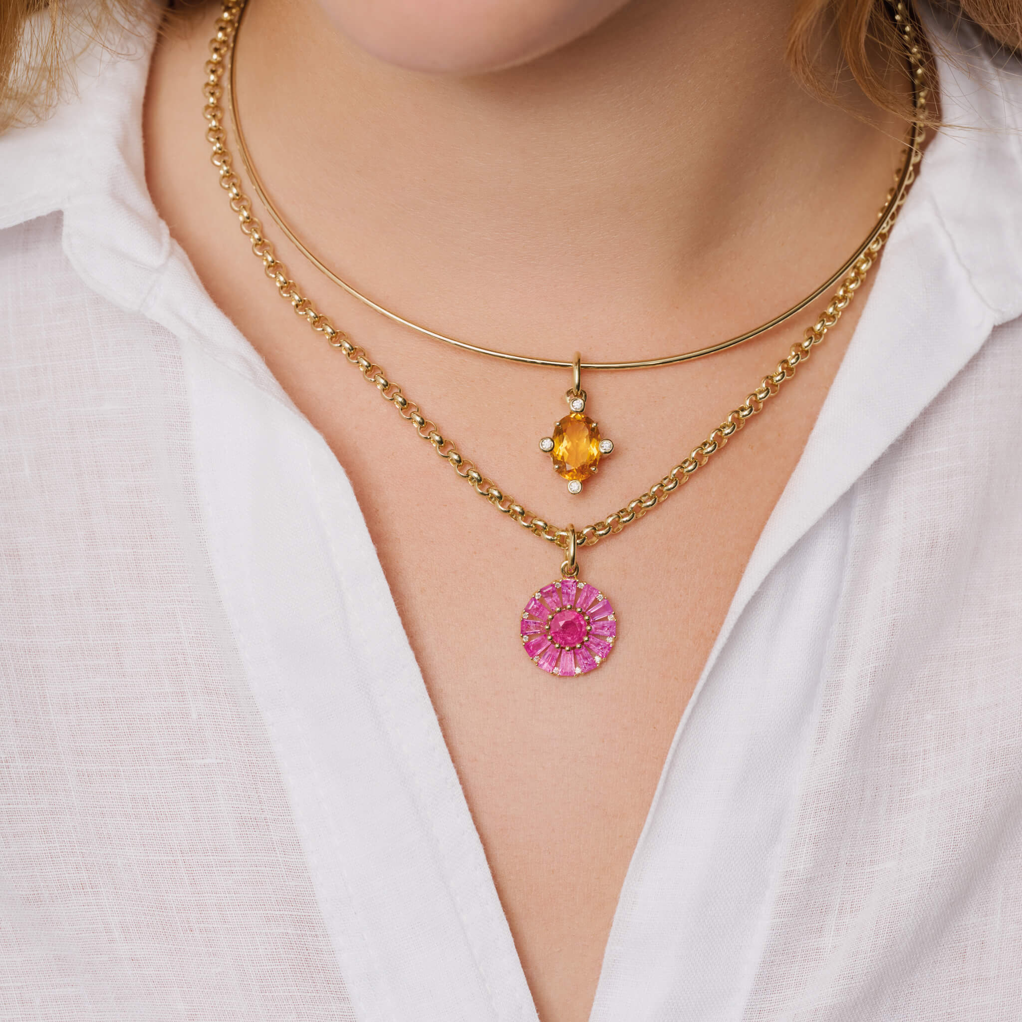 Model wears handcrafted Compass medium pendant 9ct yellow gold with citrine set with four diamonds. On gold chain with diamonds and paired with pink sapphire and diamond pendant.