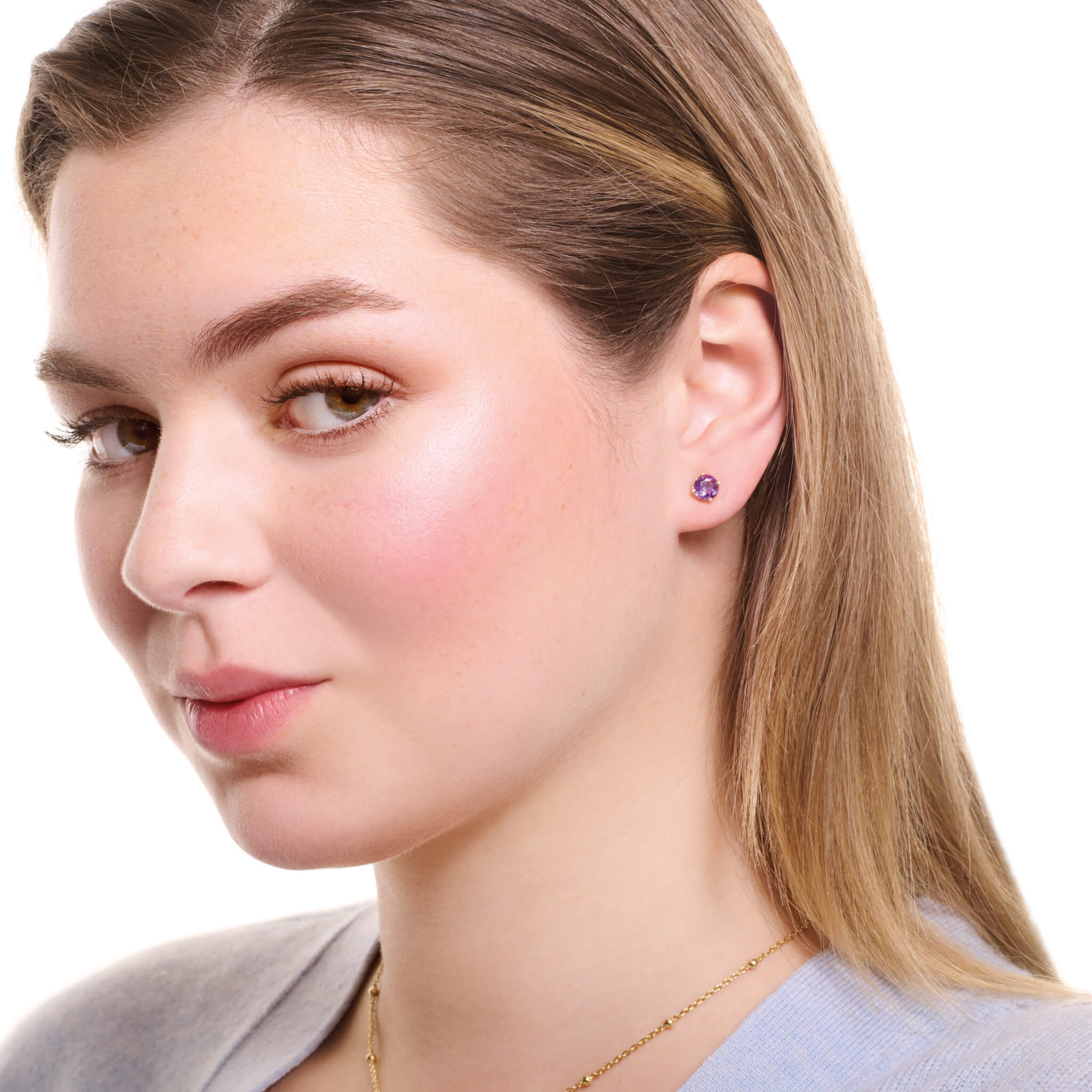Model wears handcrafted 18ct yellow gold interchangeable stud earrings featuring precious gemstone.