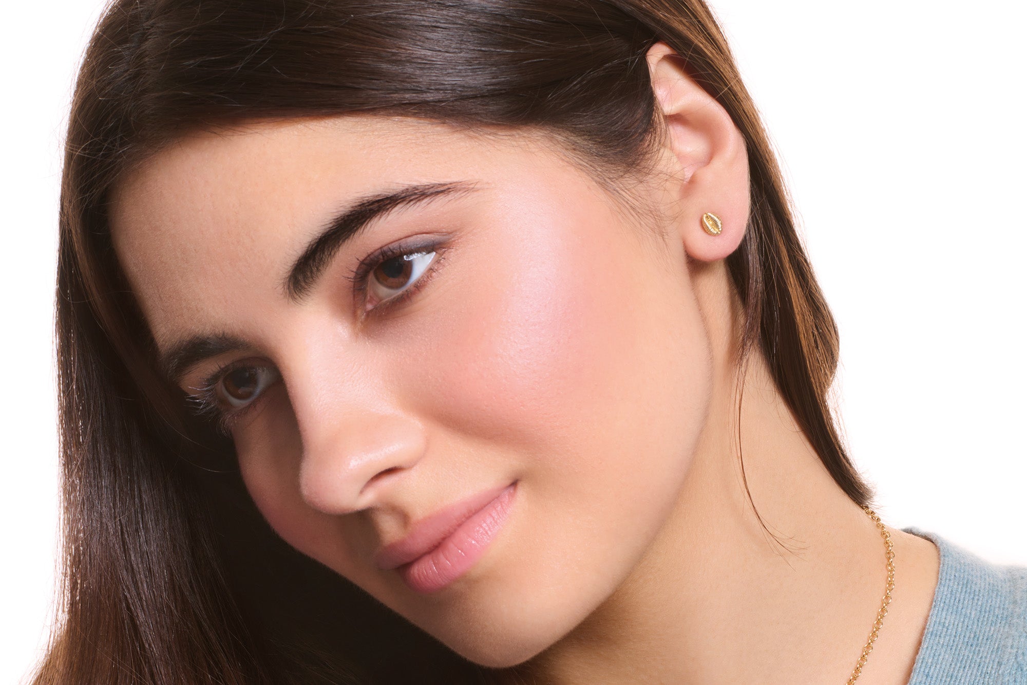 Model wearing handcrafted yellow gold stud earrings.