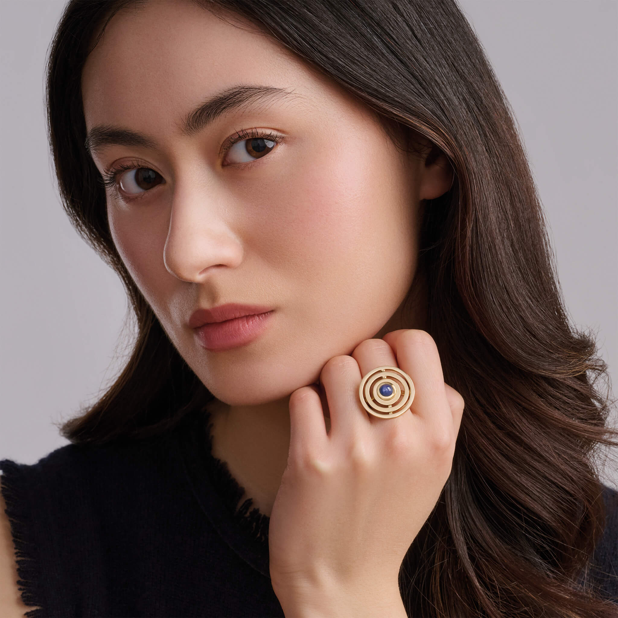 Model wearing Cassandra Goad ring with cabochon sapphire.