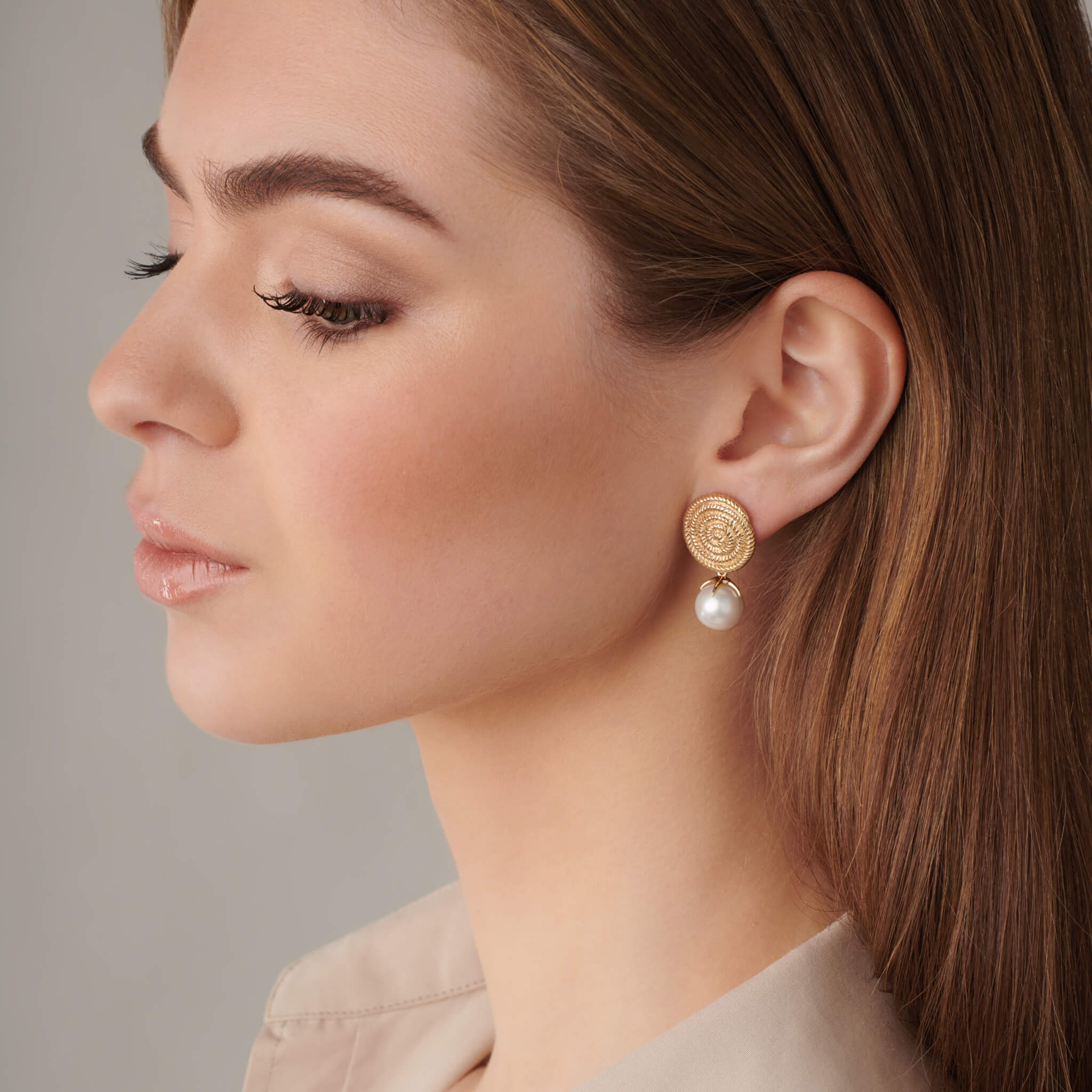 model wears handcrafted precious metal pearl earring pendant drop attached to interchangeable earrings, june birthstone