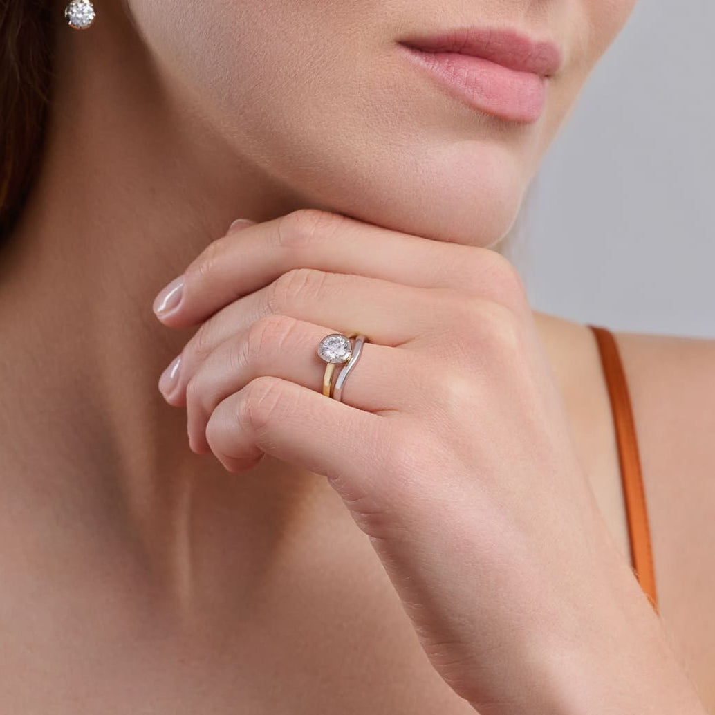 Charlotte engagement ring in yellow gold featuring a round brilliant cut diamond, handcrafted in London.