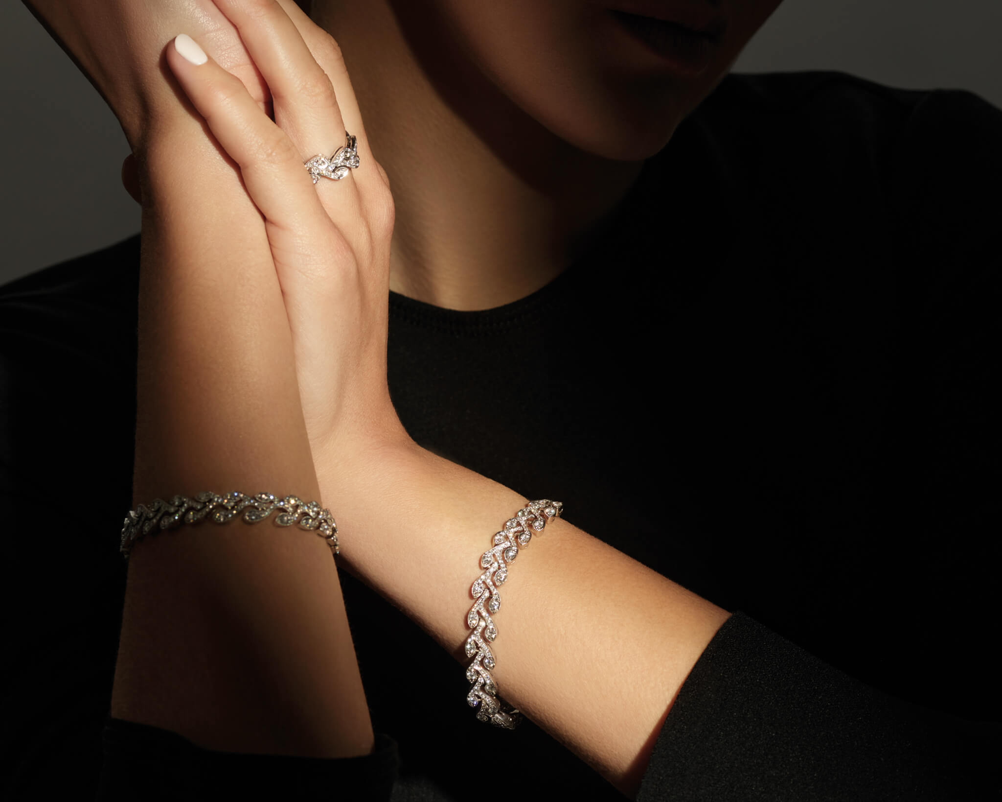Model wears the Rosemary bracelet in 18ct white and yellow gold with diamonds and Rosemary ring in 18ct yellow gold set with diamonds