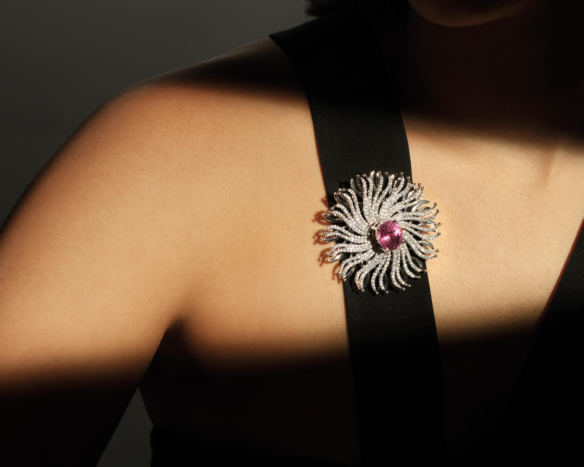 Model wears the Taj Mahal brooch in 18ct white gold with amethyst and diamonds