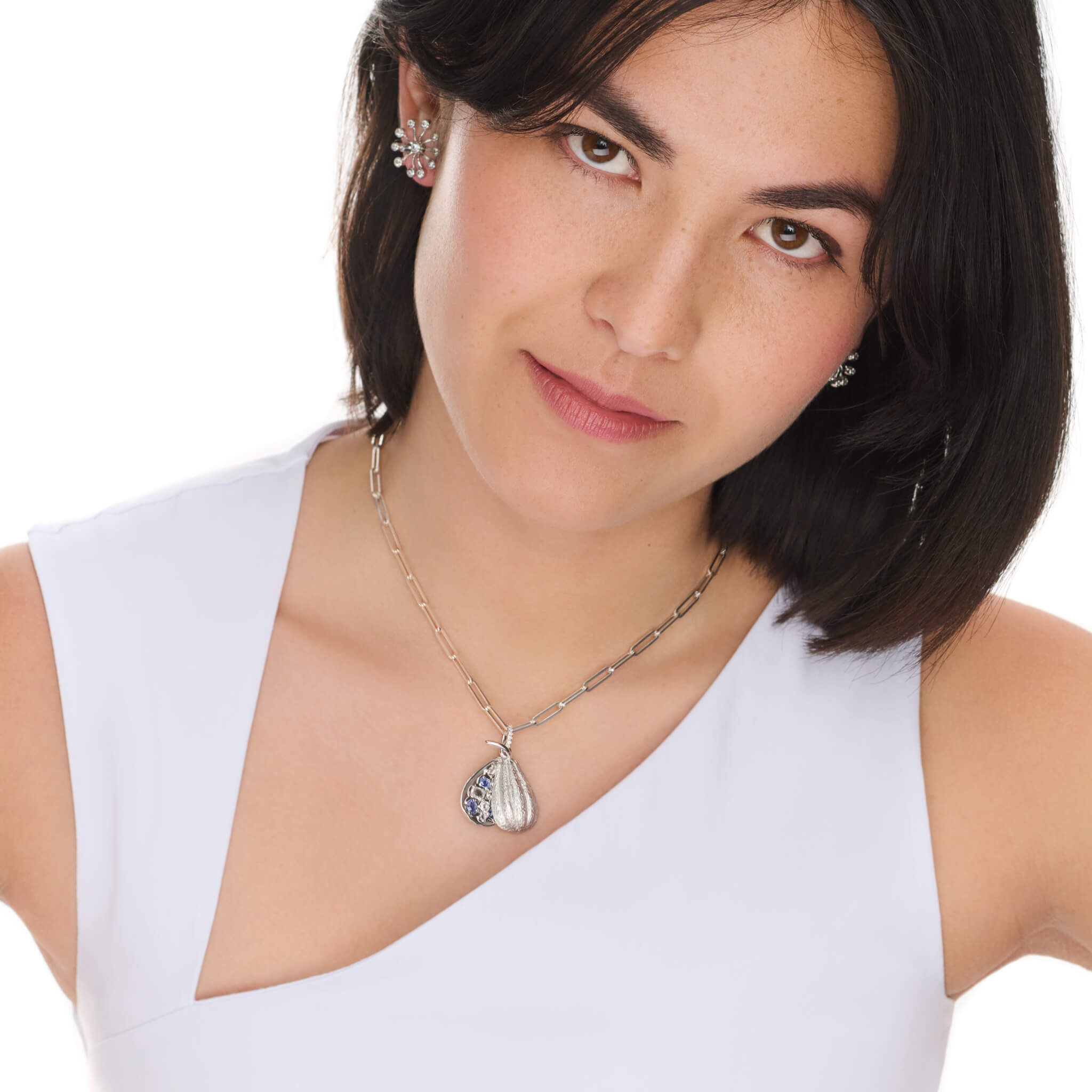 Handcrafted precious metal medium necklace pendant in the shape of a cocoa pod which swivels open. For chocolate lovers.