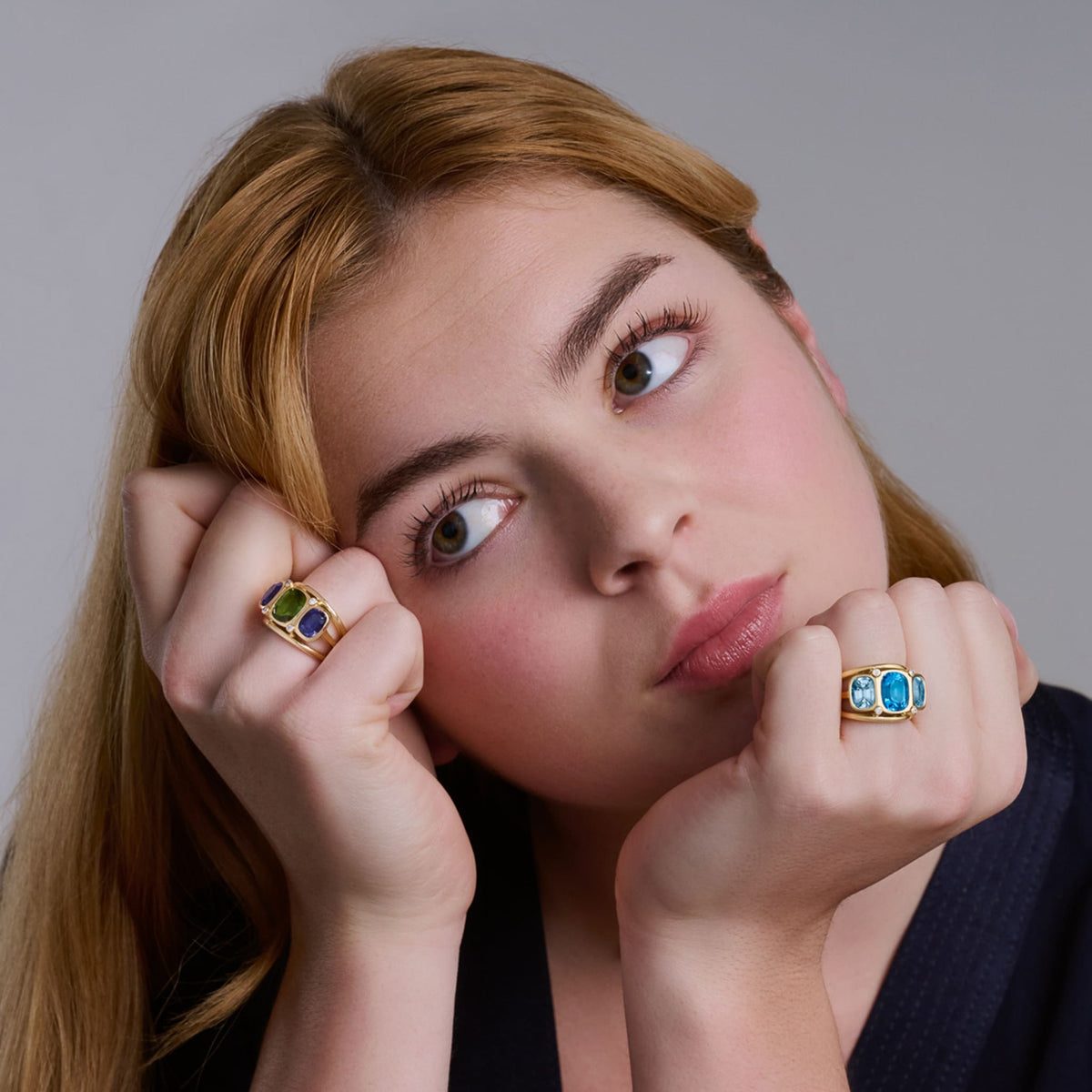 Model wears handcrafted 18ct yellow gold ring featuring a central rectangular shaped smoky quartz, two citrines and diamonds.