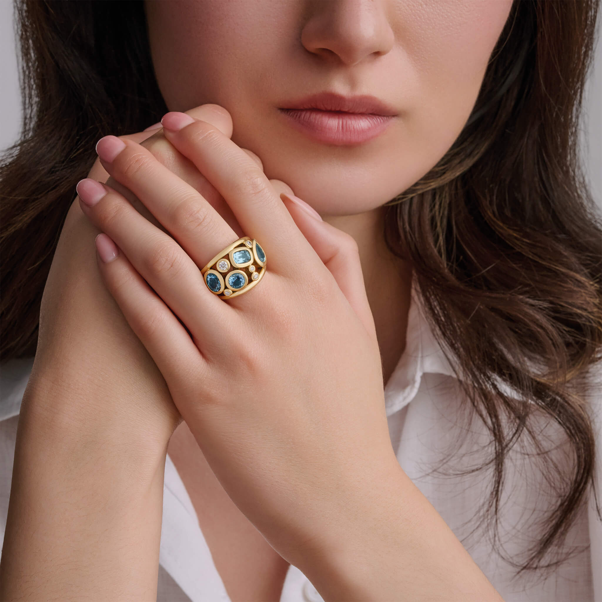 Handcrafted 18ct yellow gold ring featuring four facetted aquamarines and smaller diamonds, march birthstone