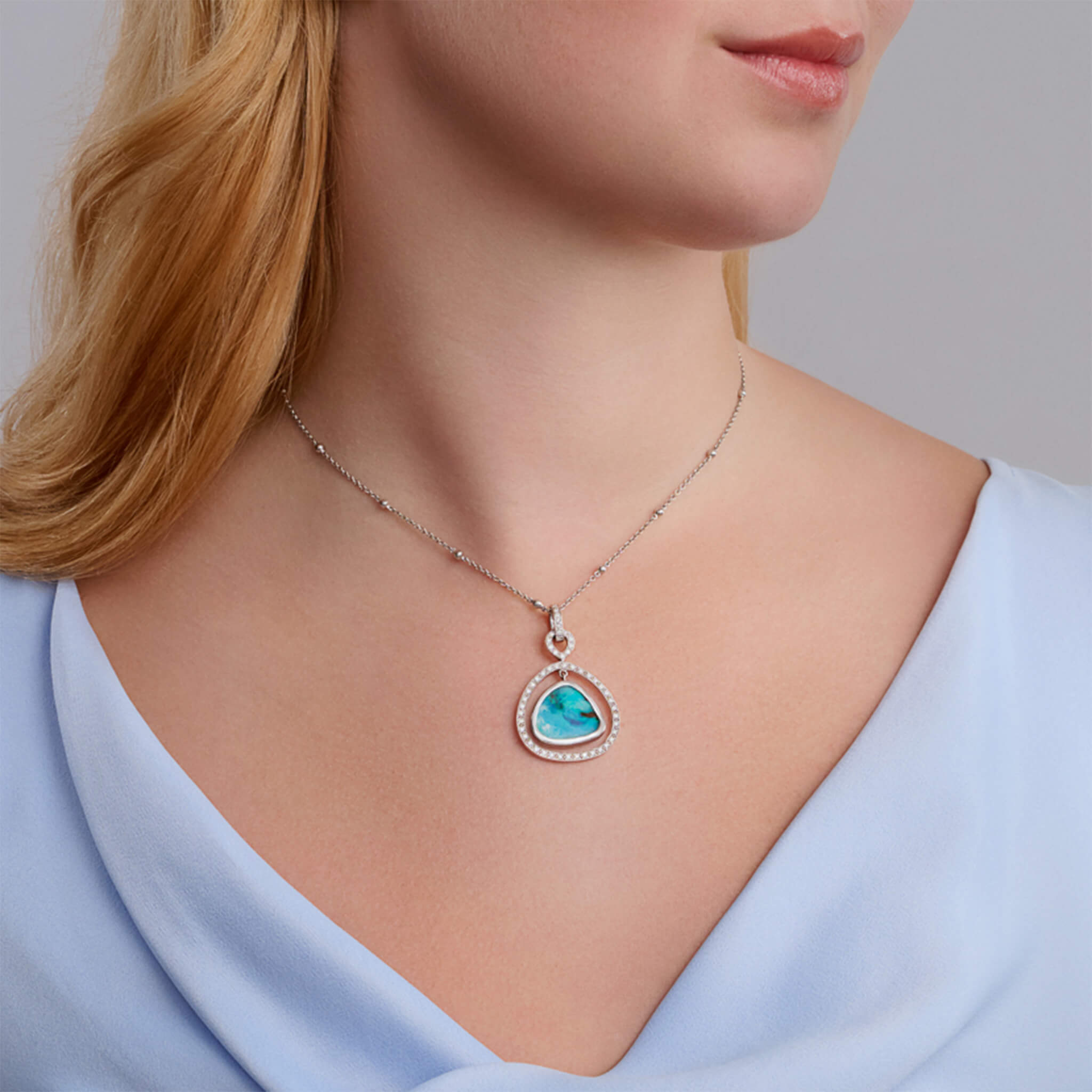 Handcrafted 18ct white gold necklace pendant featuring a teardrop-shaped opal gemstone with diamonds, birthstone of October.