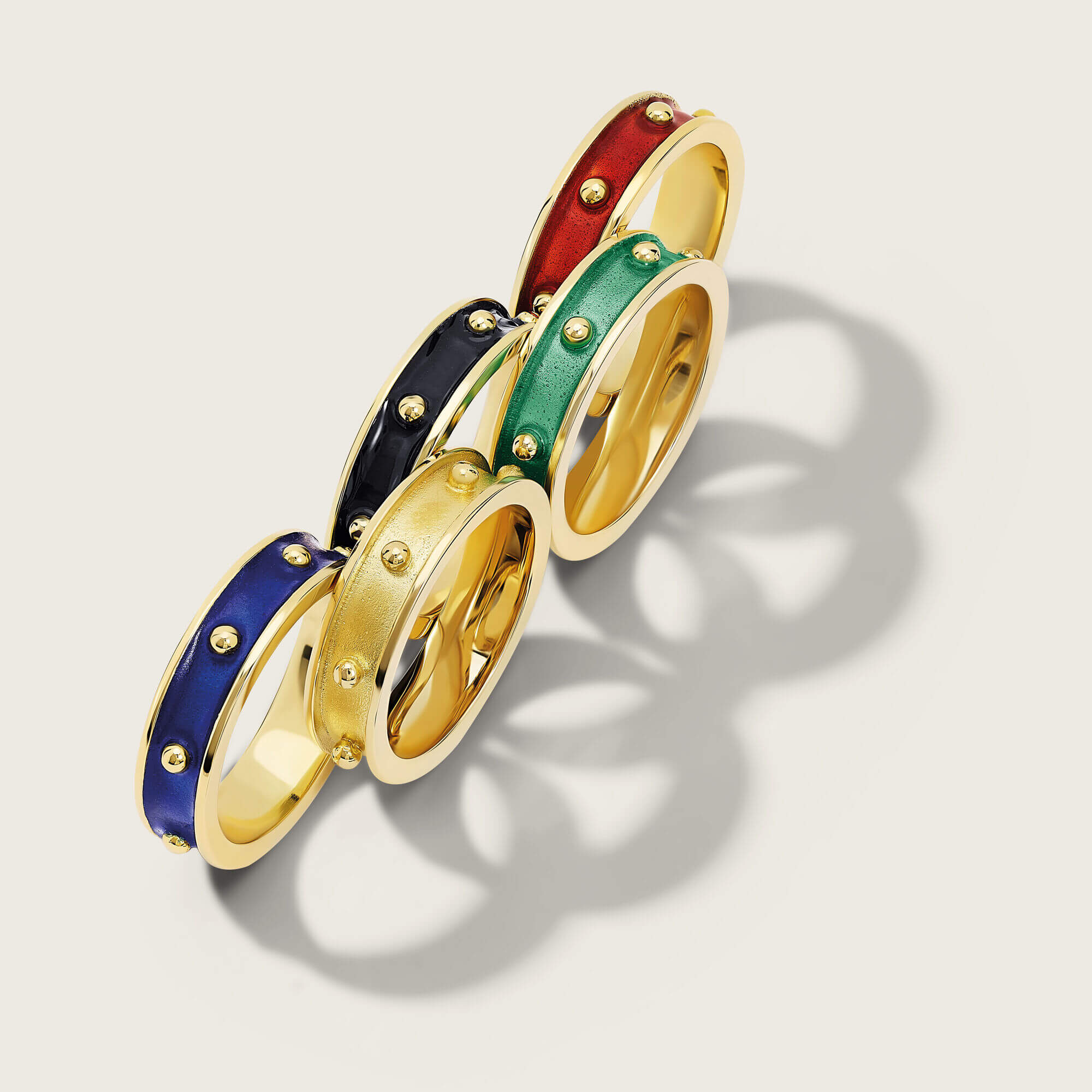 Handcrafted yellow gold decimus rings placed as the olympics logo
