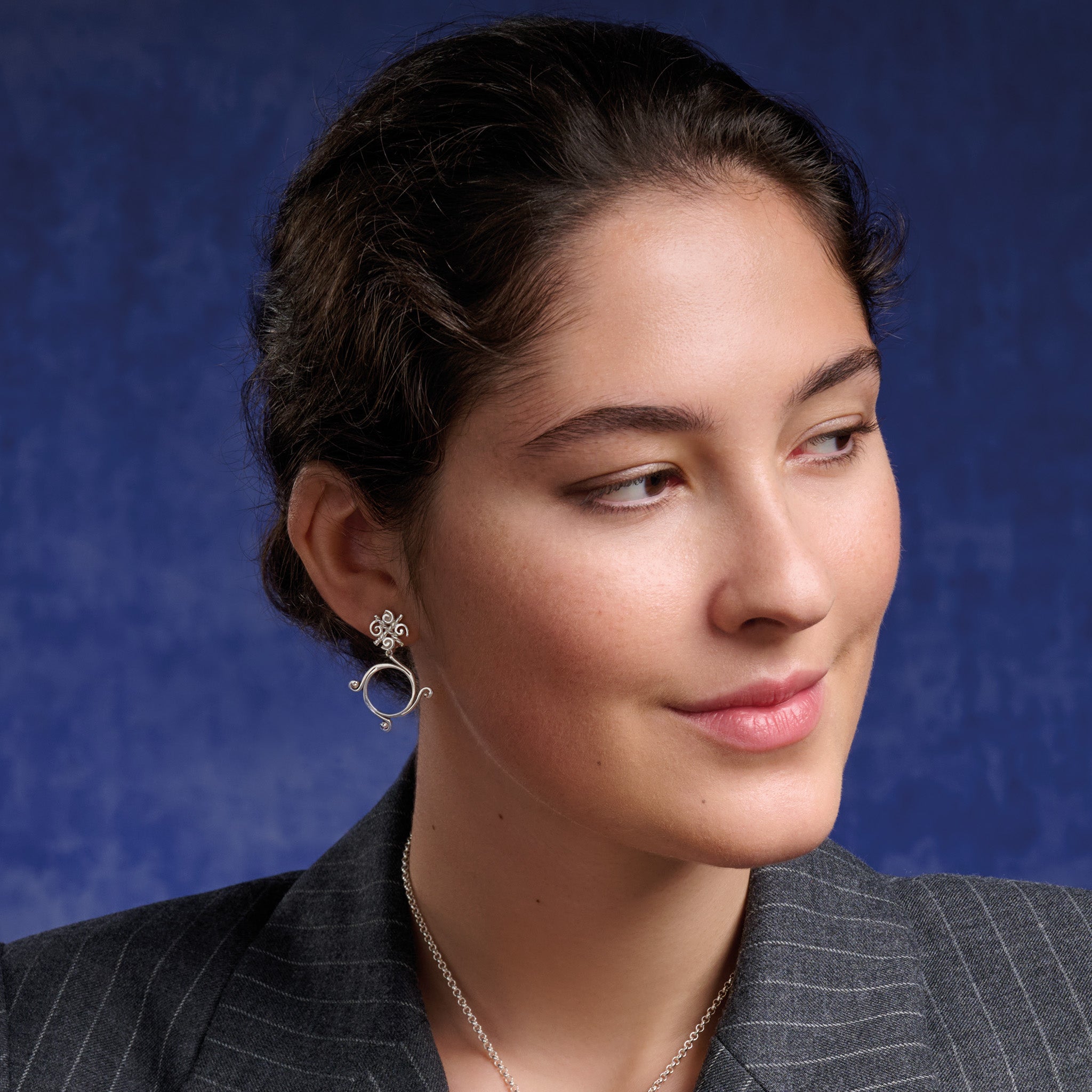 Model wears the handcrafted Pallas Athena double earrings in silver.