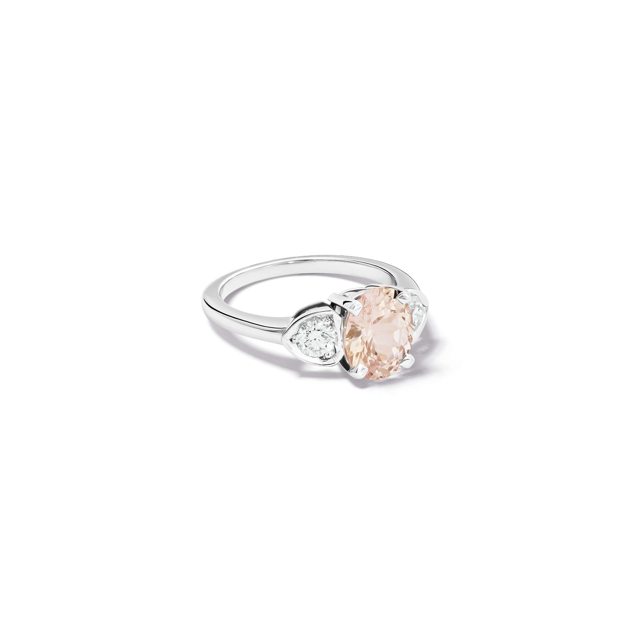 Handcrafted 18ct white gold engagement ring featuring a large central oval light pink sapphire flanked by one smaller teardrop-shaped diamond on each side.