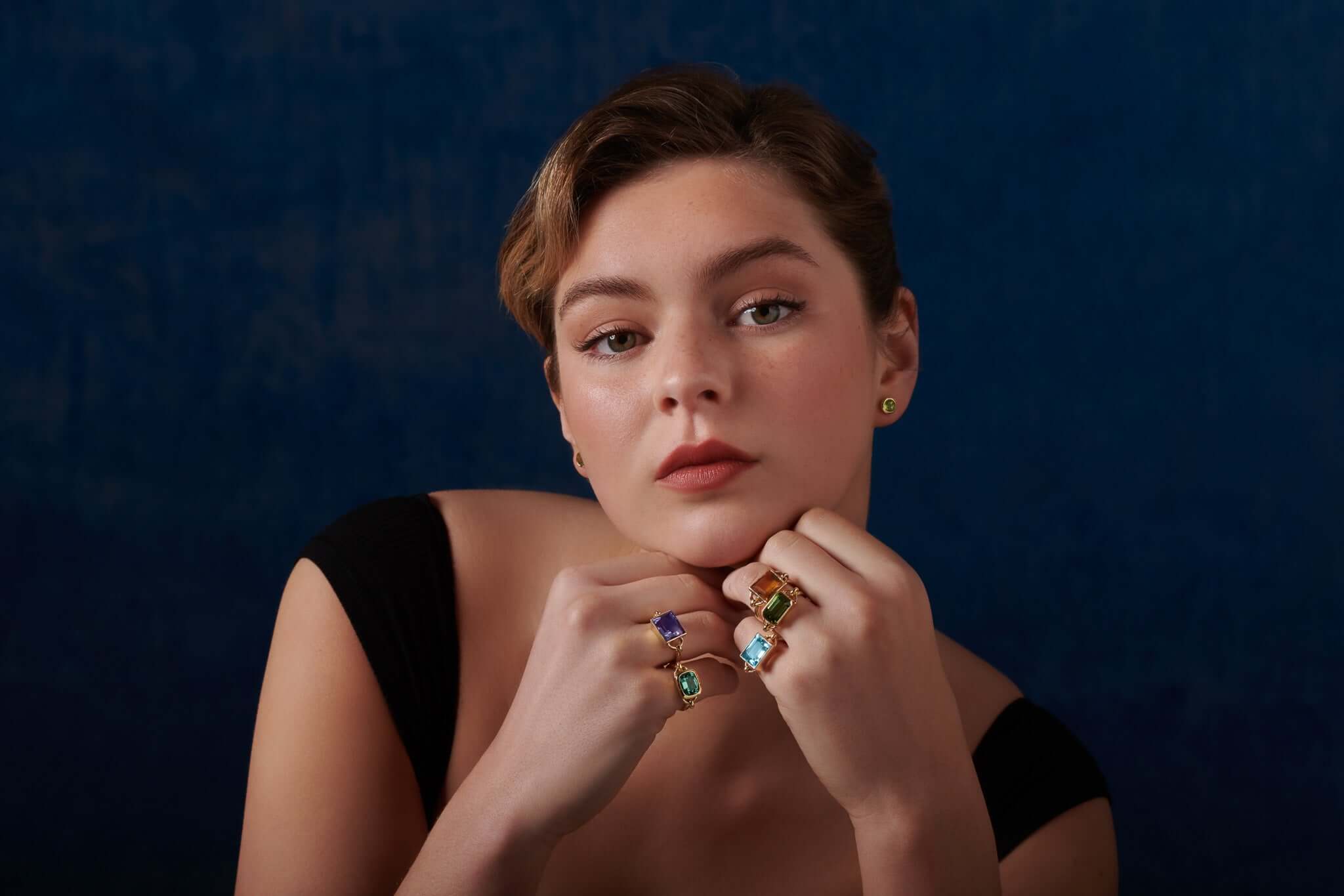 Model wearing handcrafted gold rings with precious gemstones, showcasing all ring jewellery.