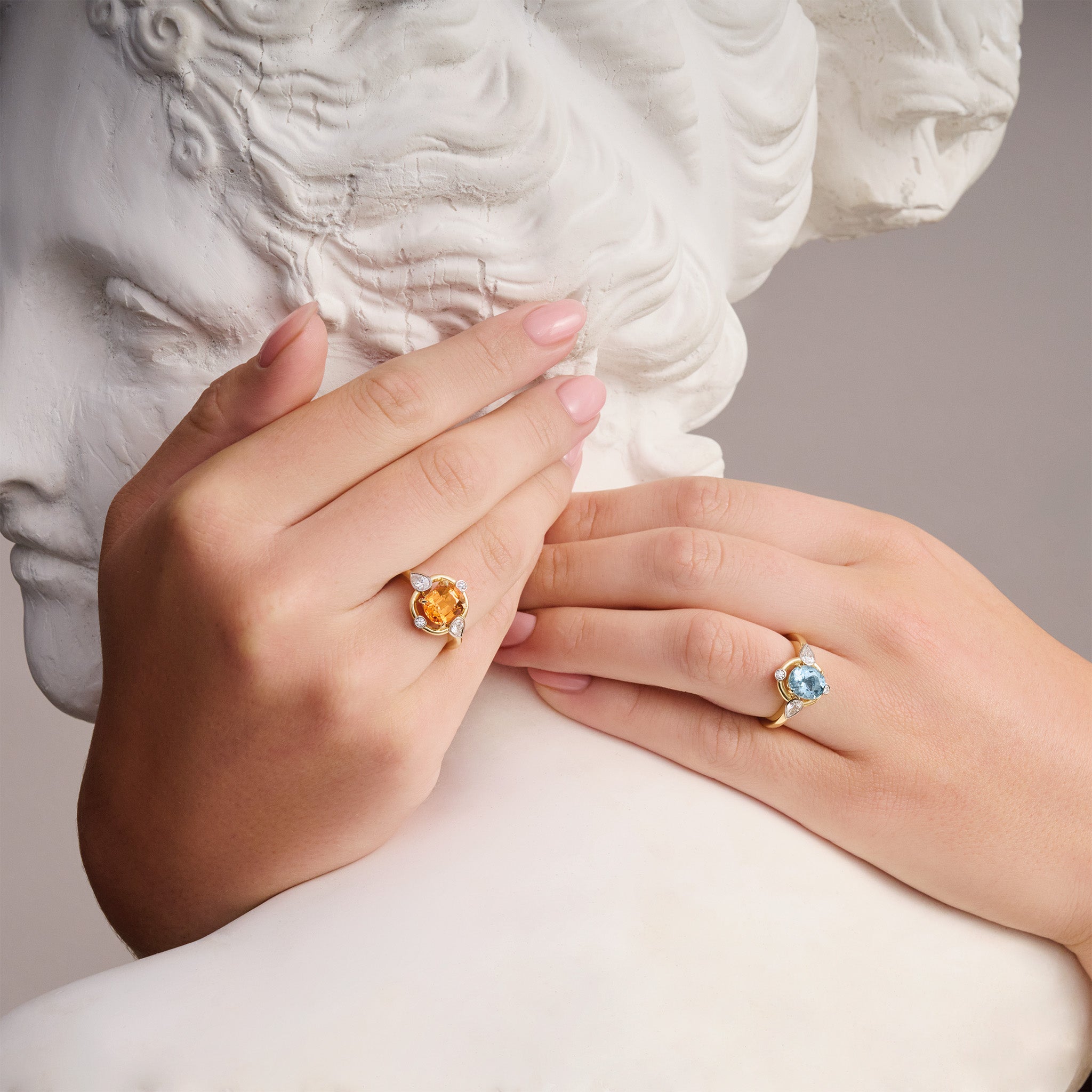 Model wearing handcrafted engagement rings made with precious stones