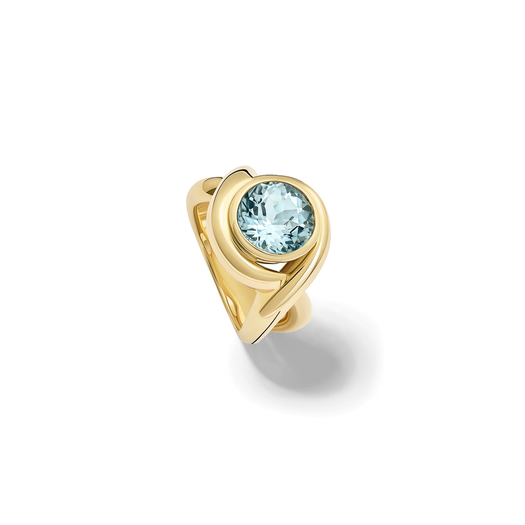 Handcrafted yellow gold ring featuring curved shanks with a round blue topaz, birthstone of November.
