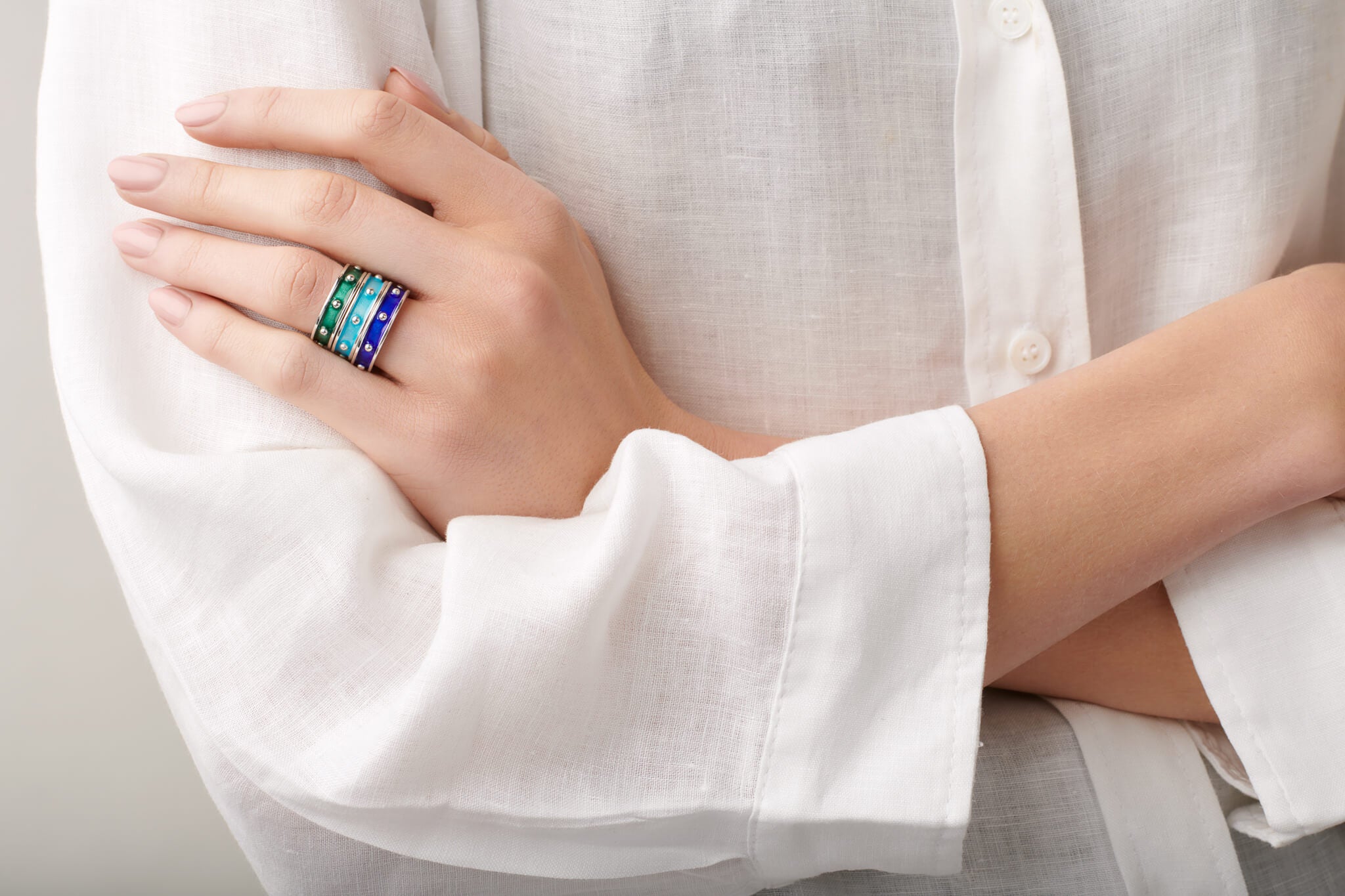 Model wearing stacked enamelled Decimus rings.