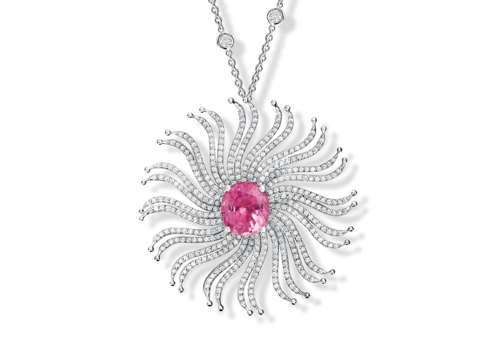 The Taj Mahal necklace pendant featuring a spiderweb-like design with a central pink sapphire gemstone and diamonds.
