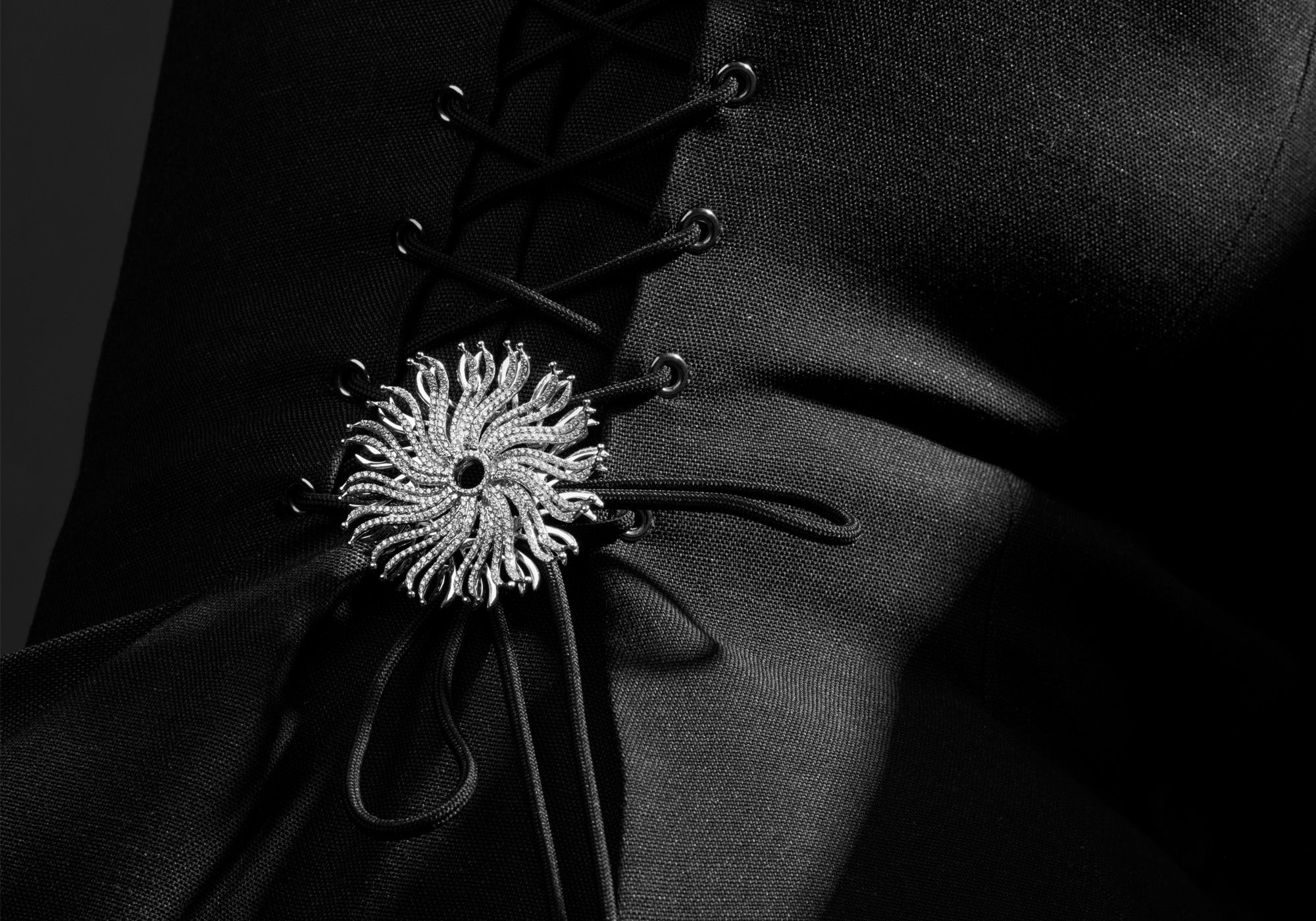 Model wearing the Taj Mahal necklace pendant featuring a spiderweb-like design with diamonds.