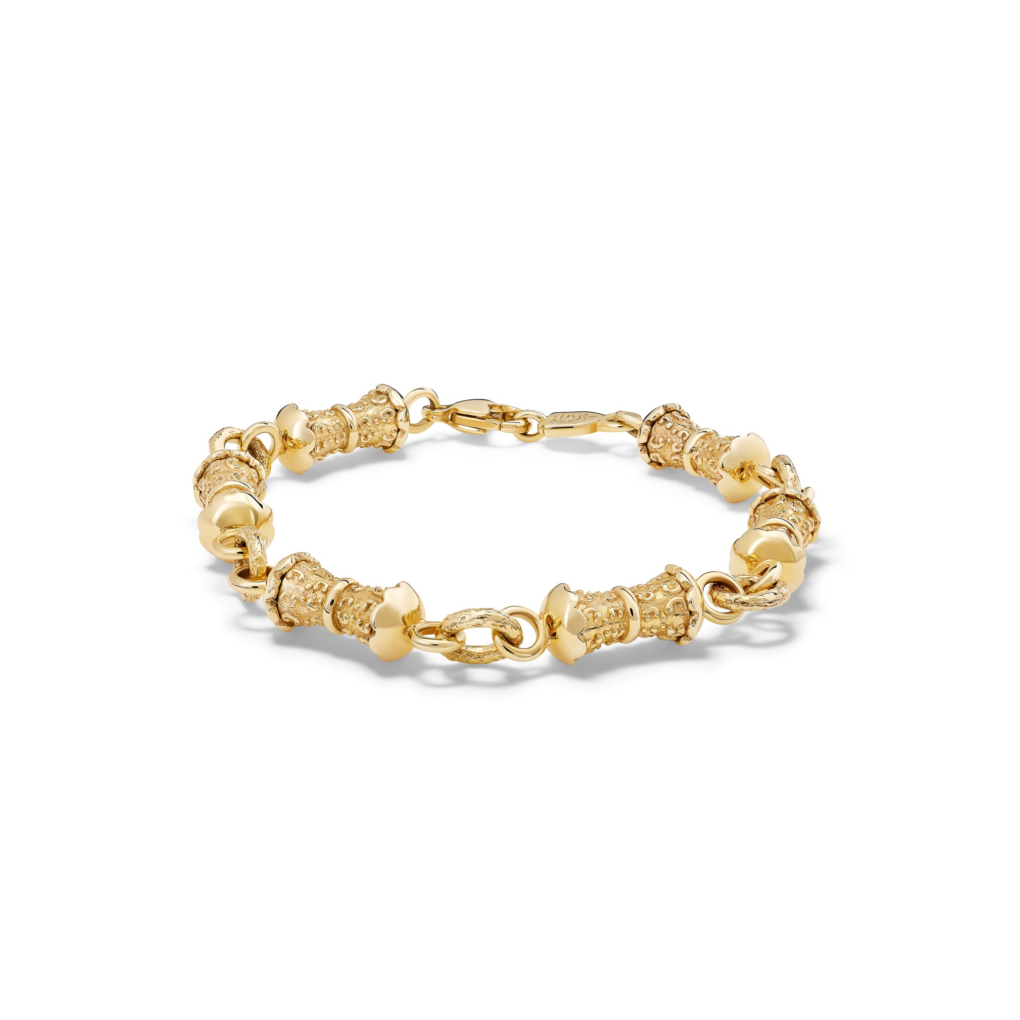 Handcrafted yellow gold bracelet featuring textured column shapes with links.