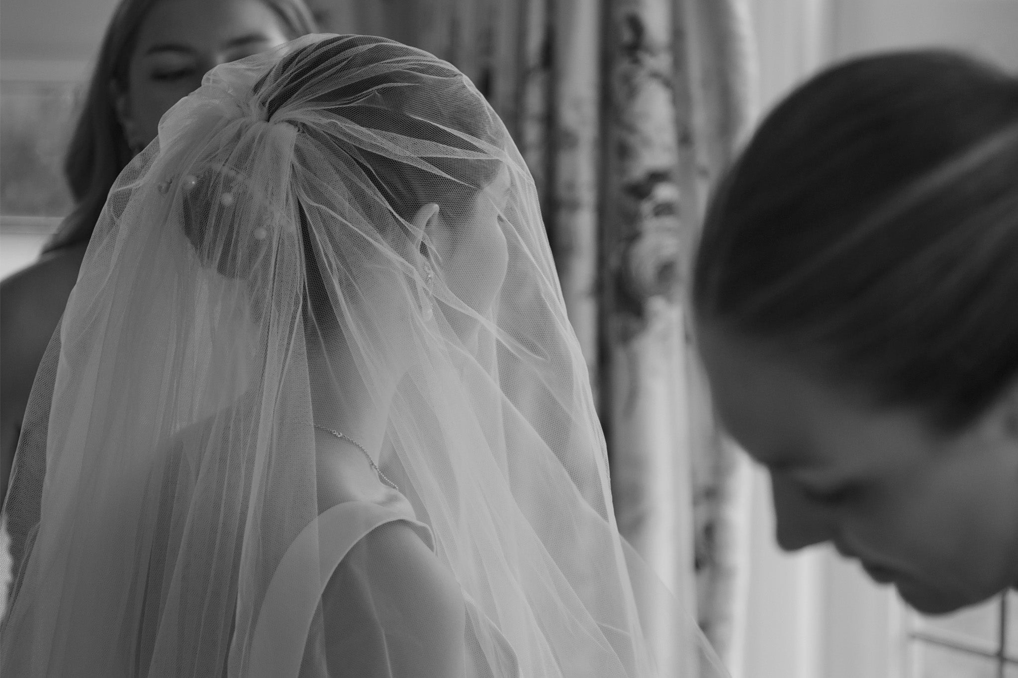 bride getting ready on her wedding day with her bridesmaids, gifting loved ones on wedding day