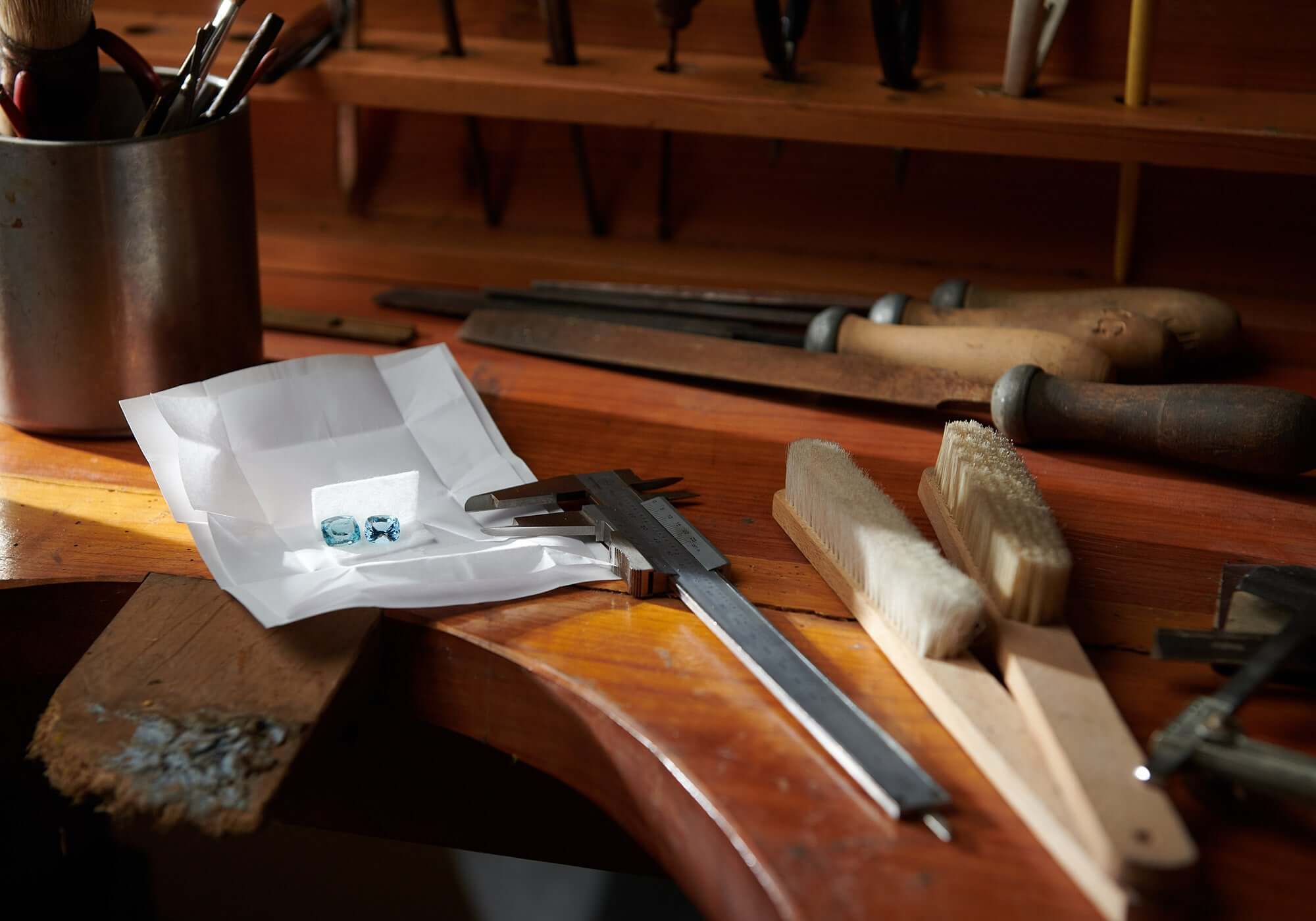 Precious blue gemstones on a workshop bench.