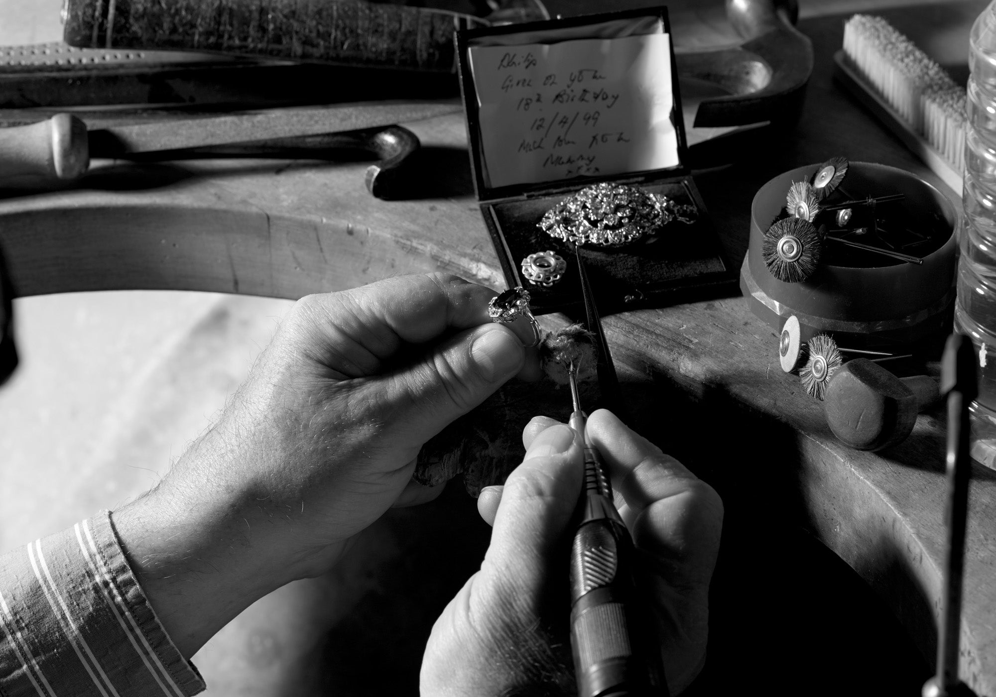 Craftsman polishing an engagement ring.