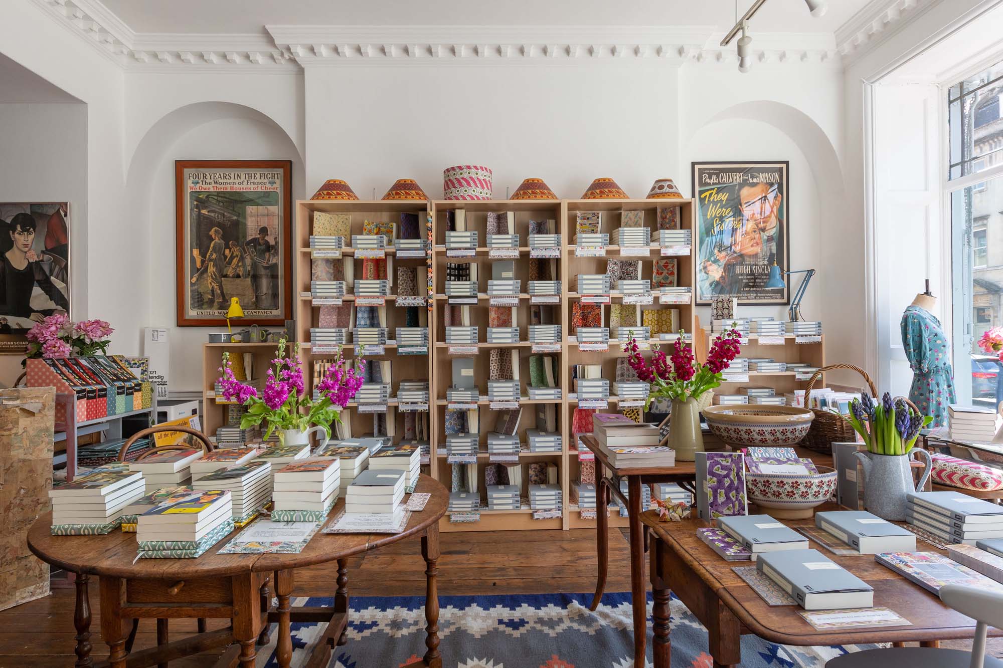 Persephone quaint bookstore in Bath with wooden bookshelf and tables. 