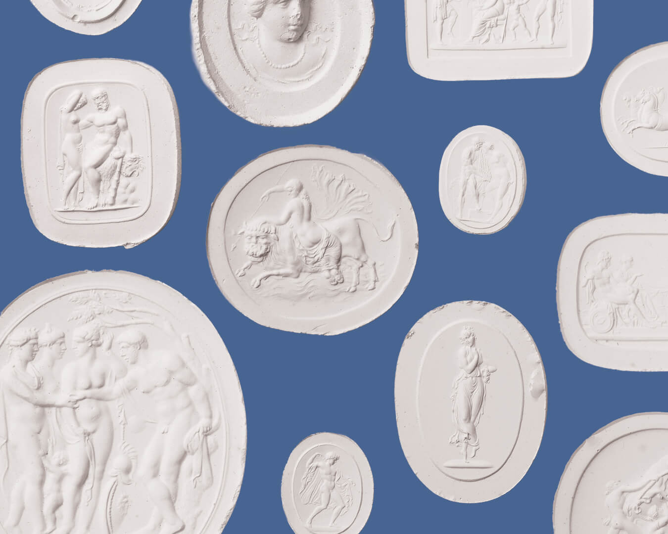 A collection of white classical relief-style decorative plaques and medallions