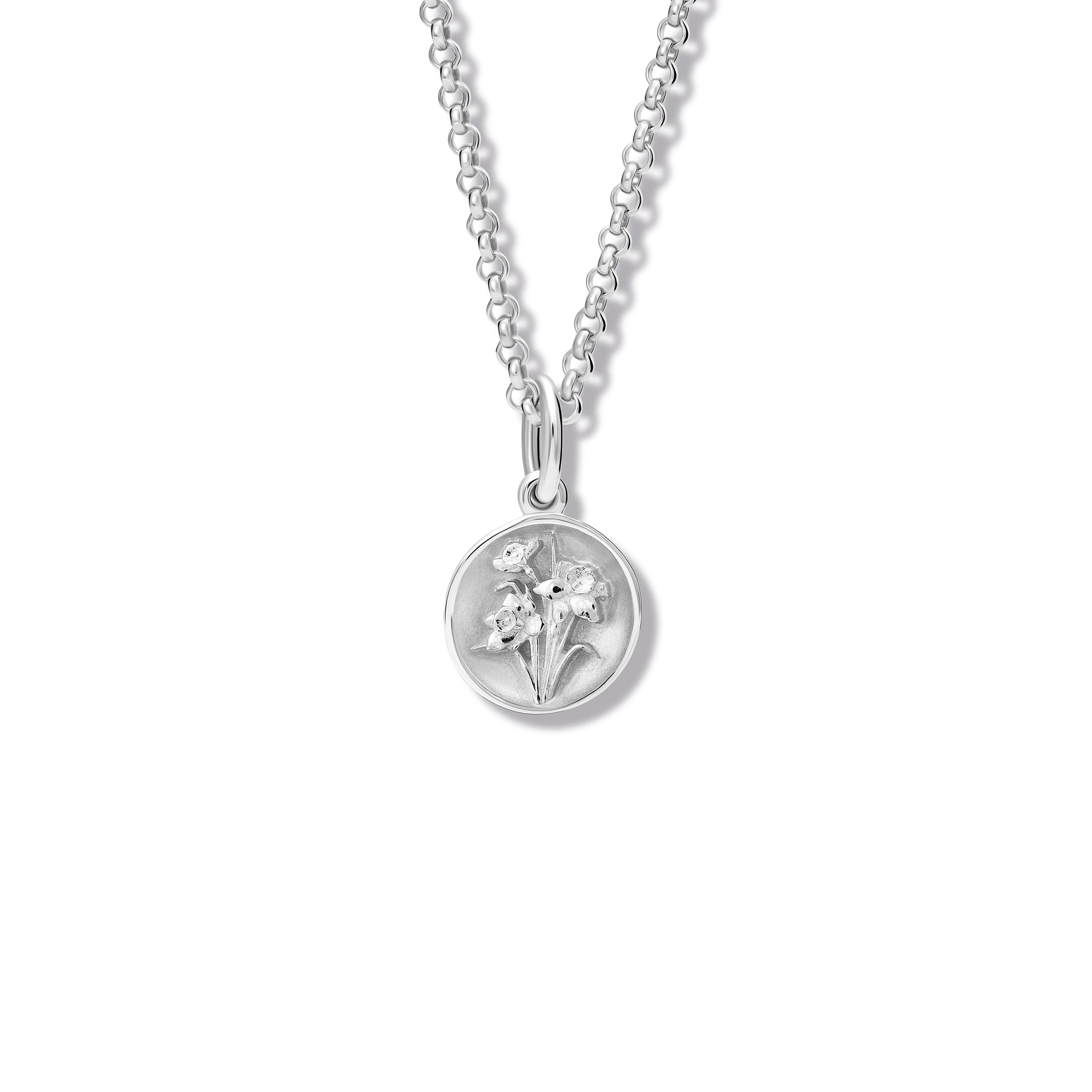 Handcrafted round sterling silver necklace pendant featuring an 'en relief' daffodil flower.