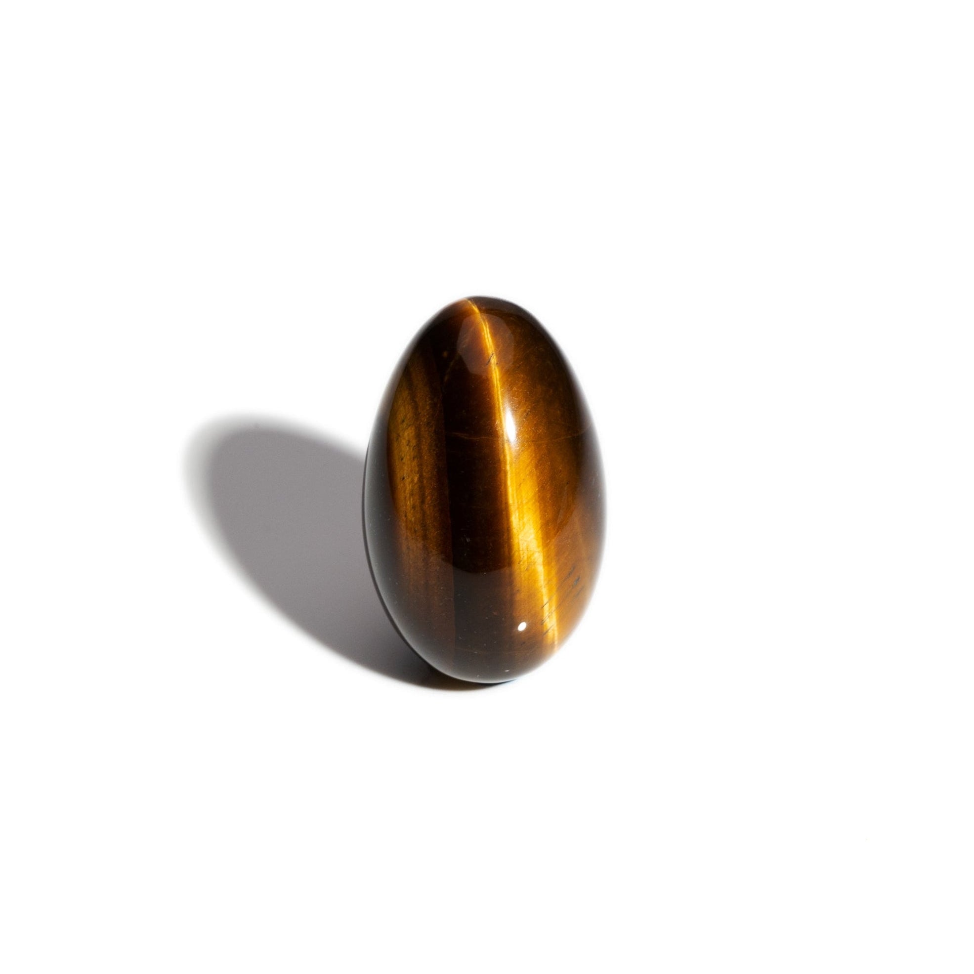 A handcrafted gemstone egg in the precious stone tiger's eye.