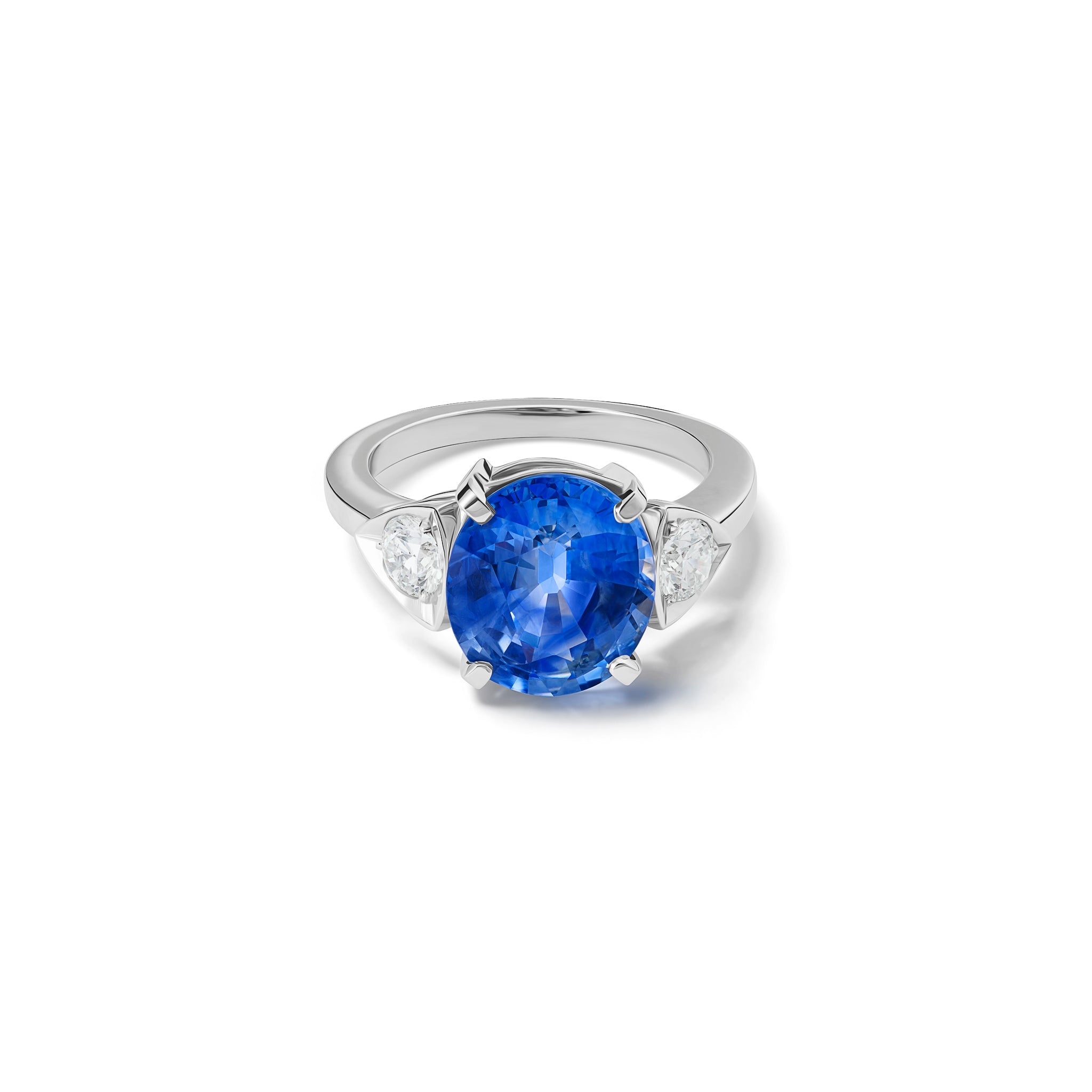 Handcrafted 18ct white gold engagement ring featuring a large central oval sapphire flanked by one smaller teardrop-shaped diamond on each side.