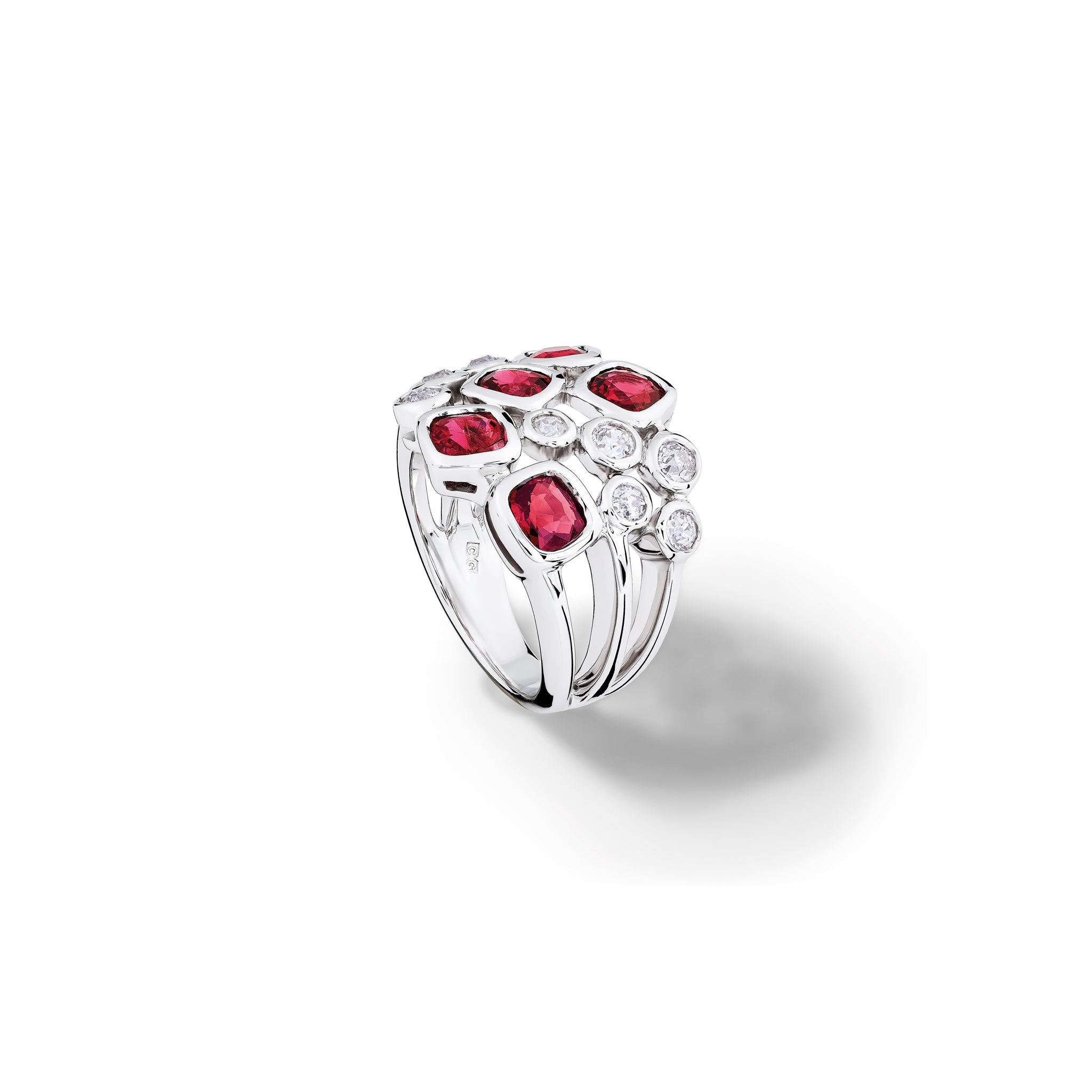 Handcrafted 18ct white gold ring featuring different sized round red spinels and diamonds. 