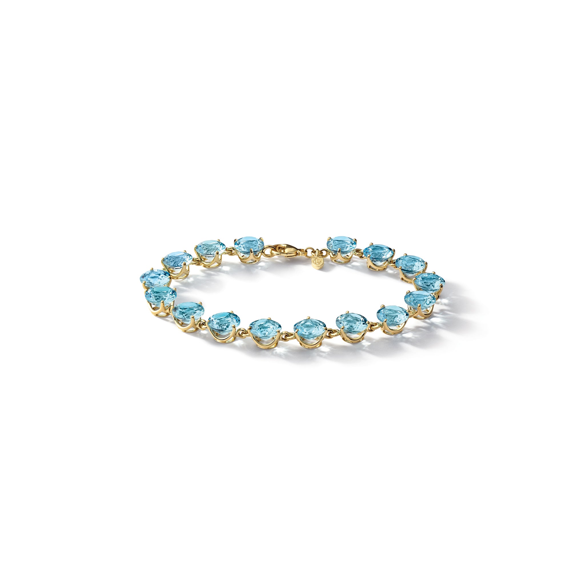 Handcrafted yellow gold bracelet featuring circular blue topaz gemstones.
