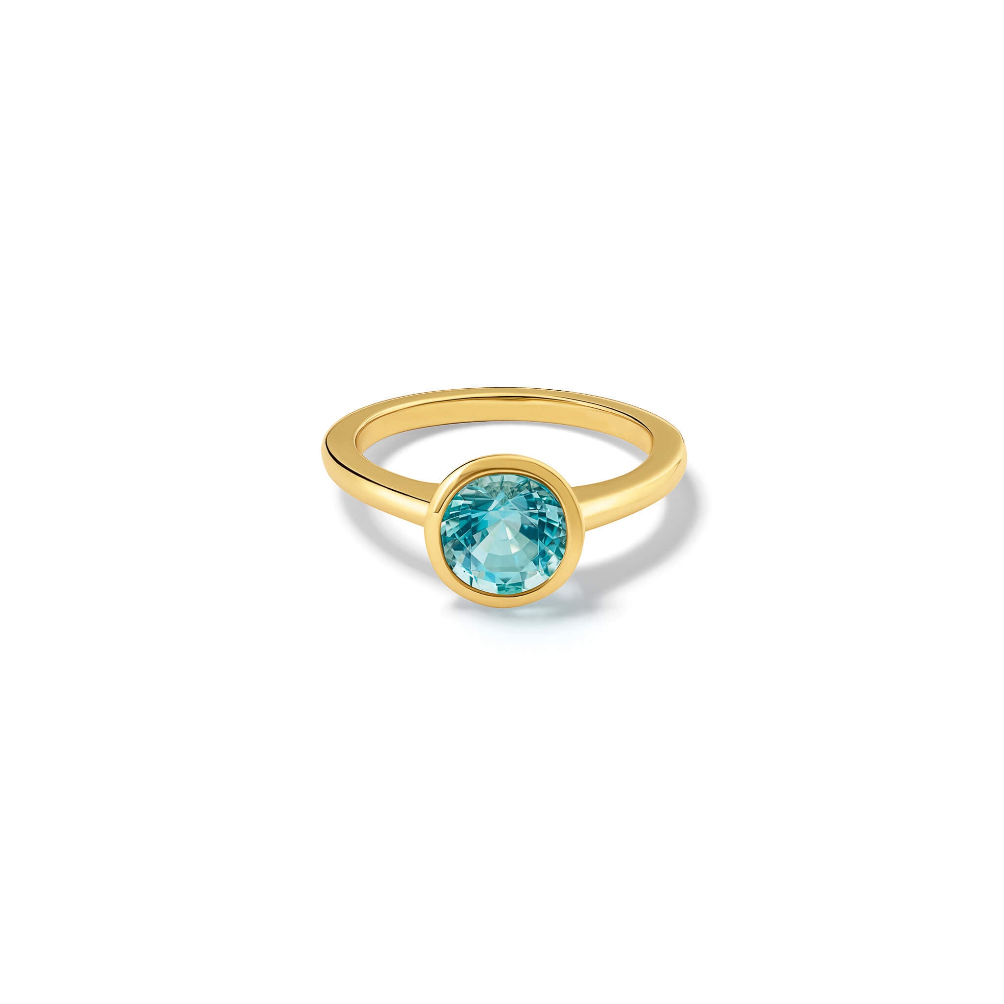 Handmade 18ct yellow gold engagement ring featuring a round central aquamarine in a rub over setting.