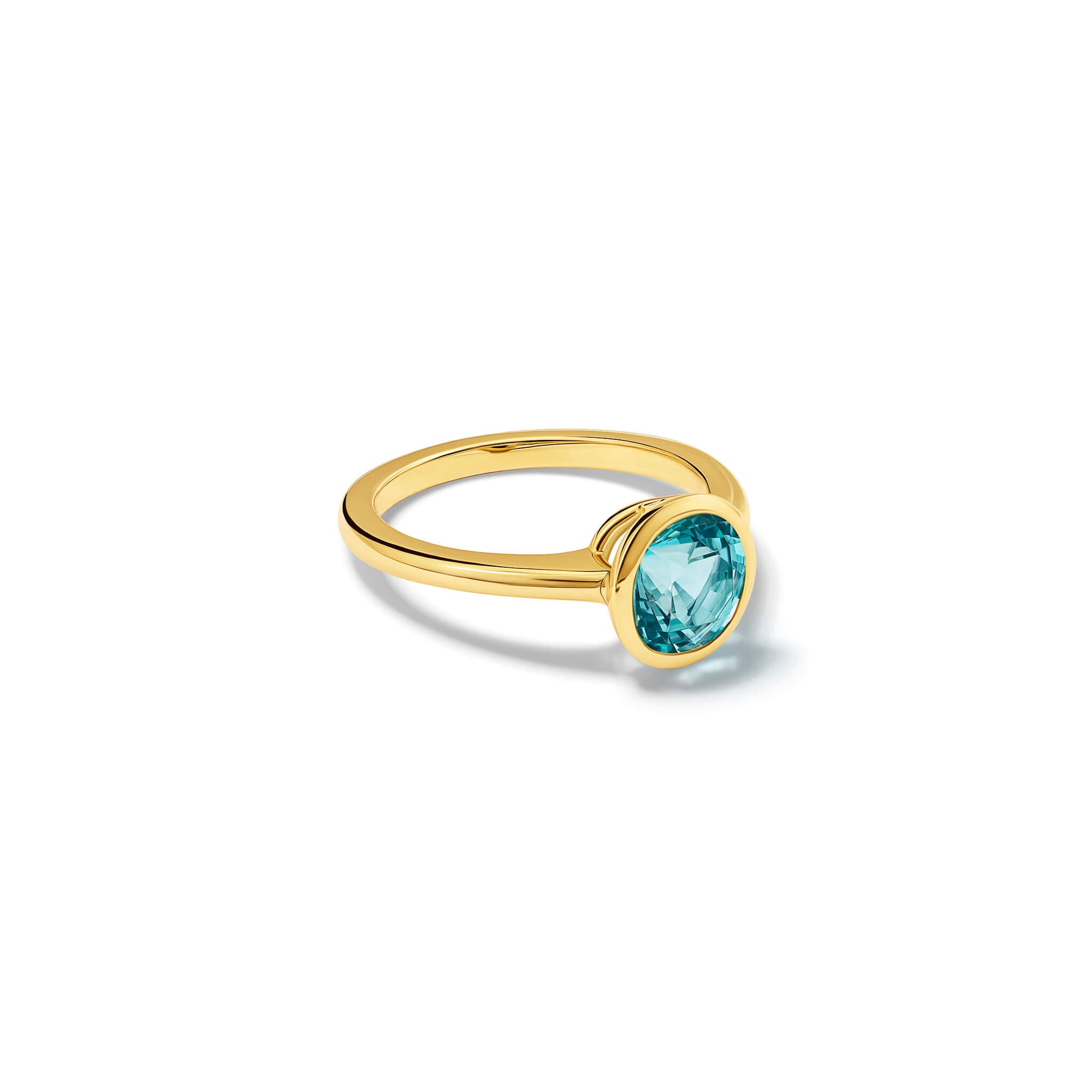 Handmade 18ct yellow gold engagement ring featuring a round central aquamarine in a rub over setting.