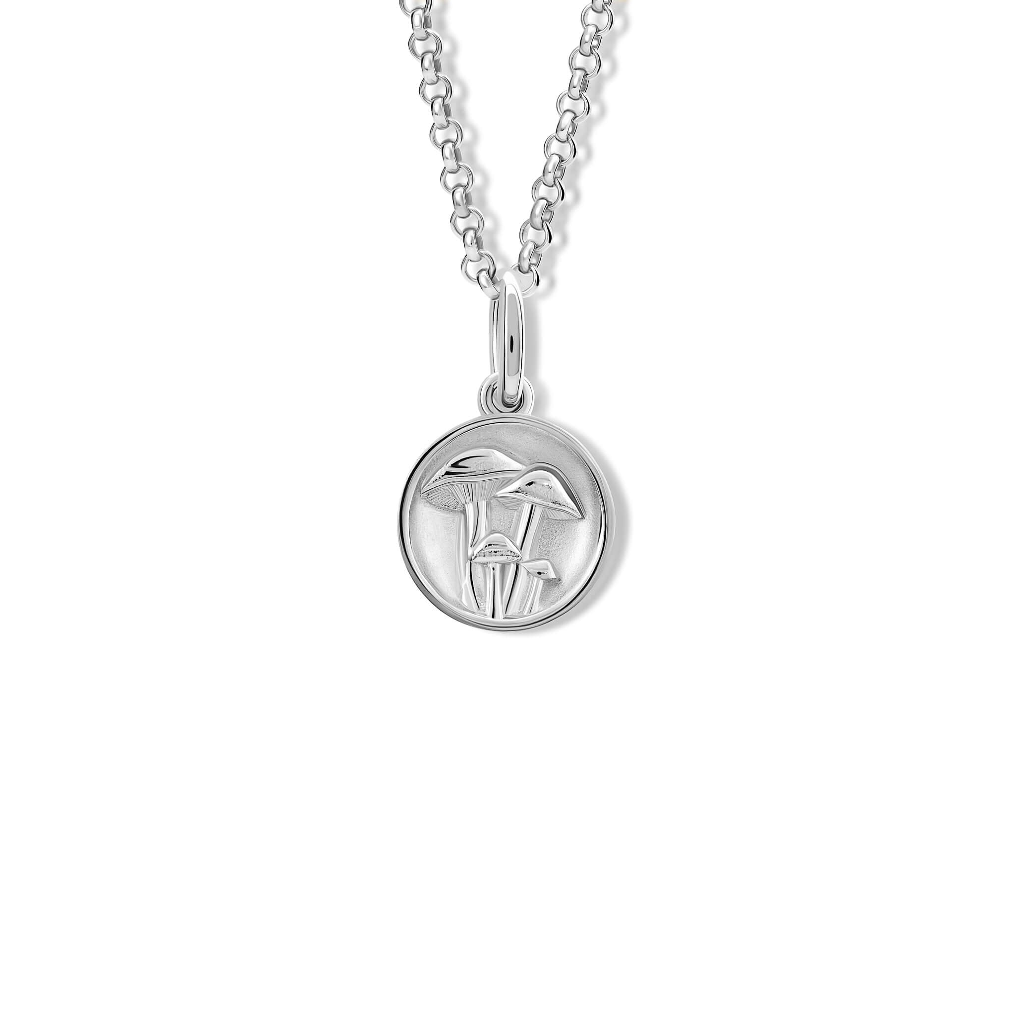 A handcrafted silver pendant with a mushroom 'in relief'