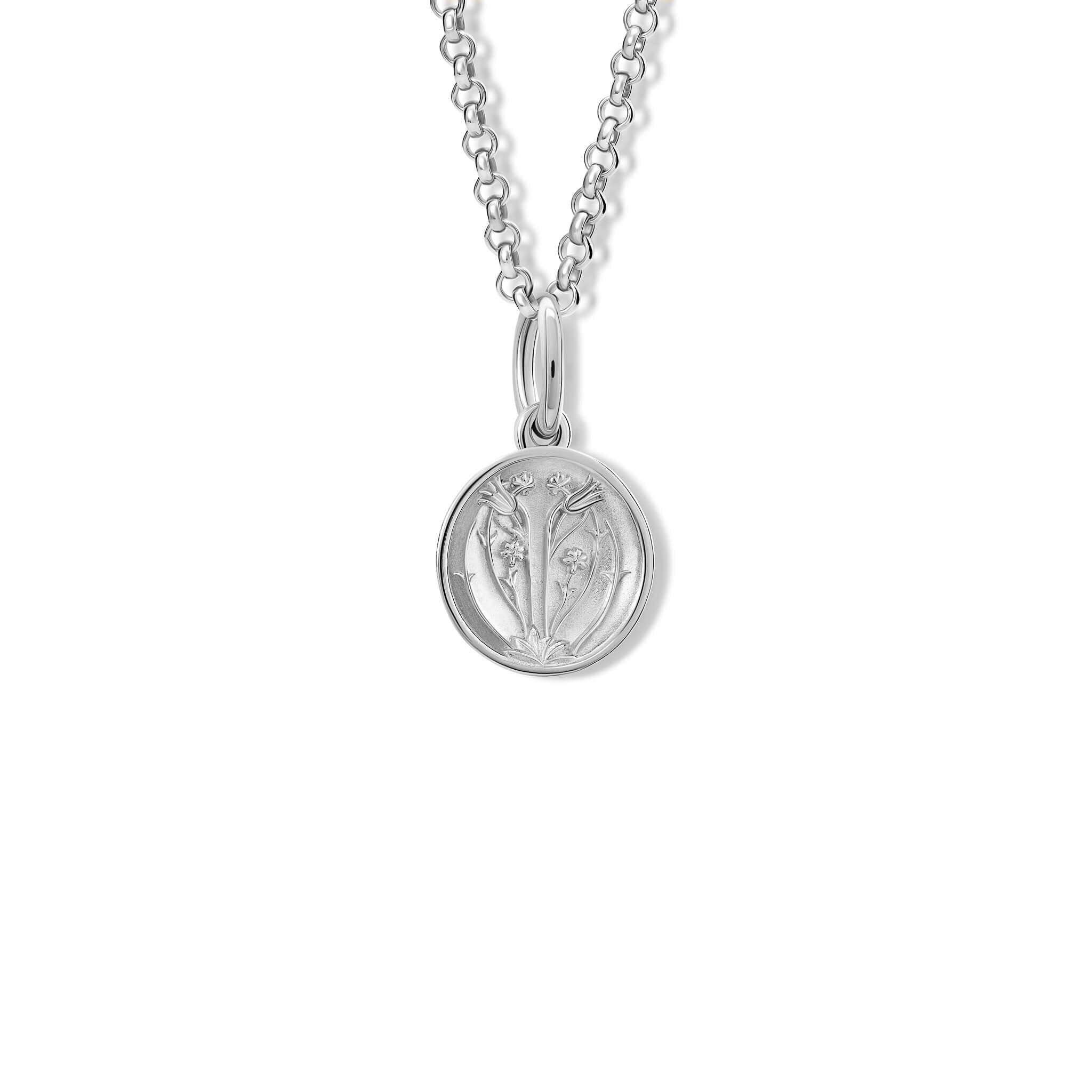 A handcrafted pendant with a tulip 'in relief'