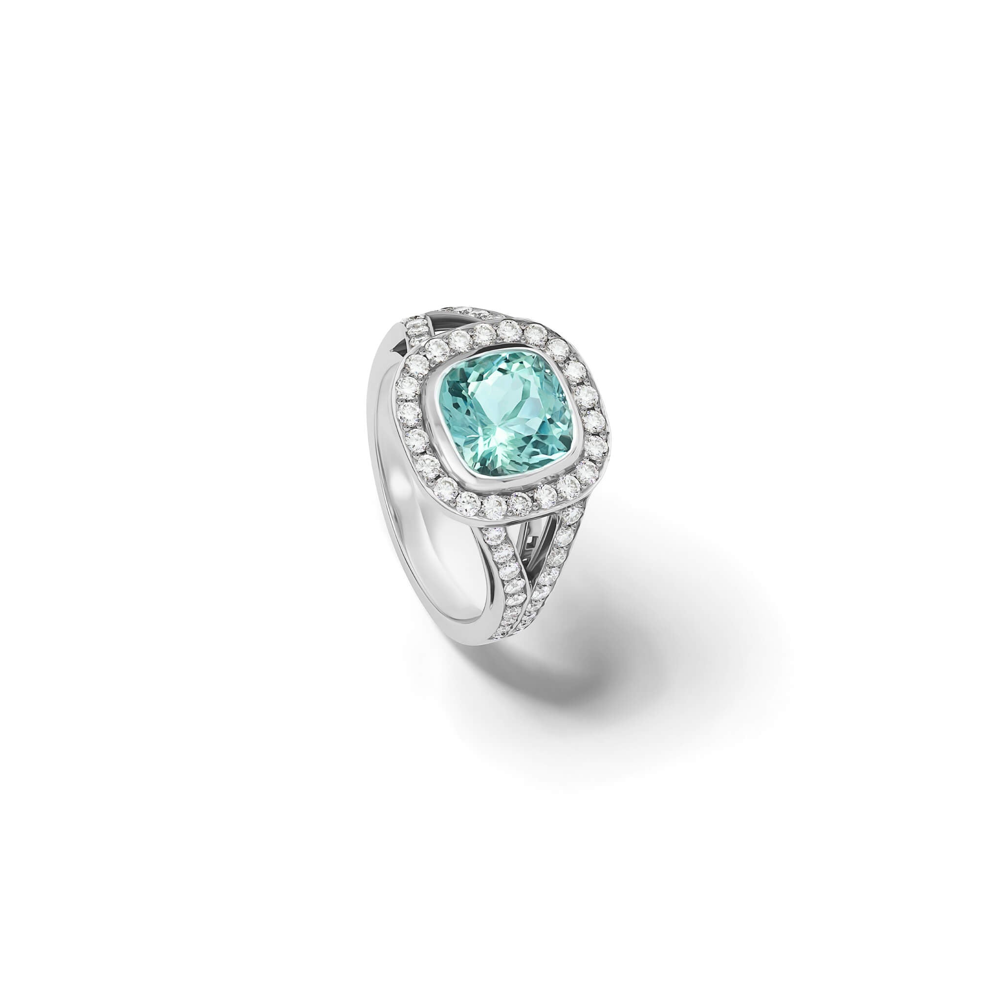 Handcrafted 18ct white gold engagement ring featuring a rub over set cushion-cut aquamarine surrounded by a halo of small diamonds and smaller diamonds embedded along the band.
