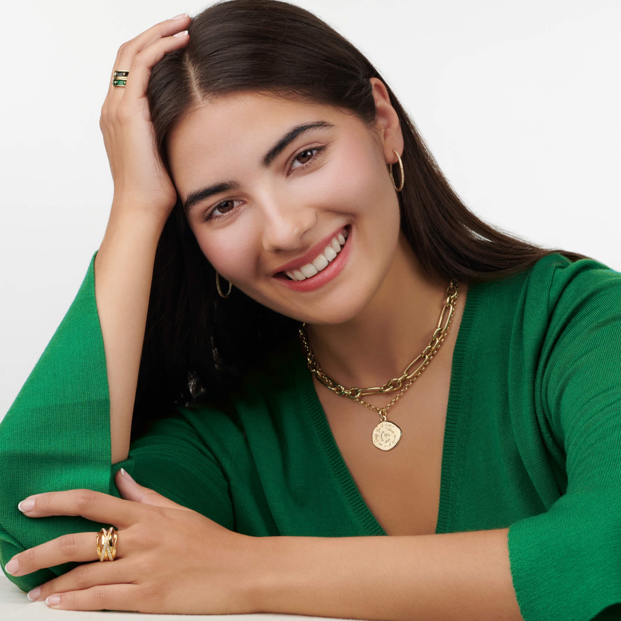 Model wearing a handcrafted round 18ct yellow gold pendant necklace engraved with a quote of wisdom.