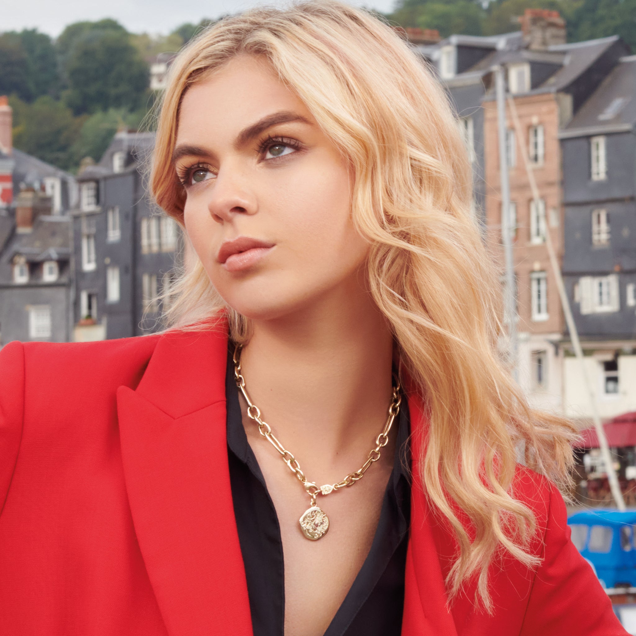 Model wearing a handcrafted yellow gold necklace pendant engraved with the quote, 'Give me the serenity to accept the things I cannot change, the courage to change the things I can, and the wisdom to