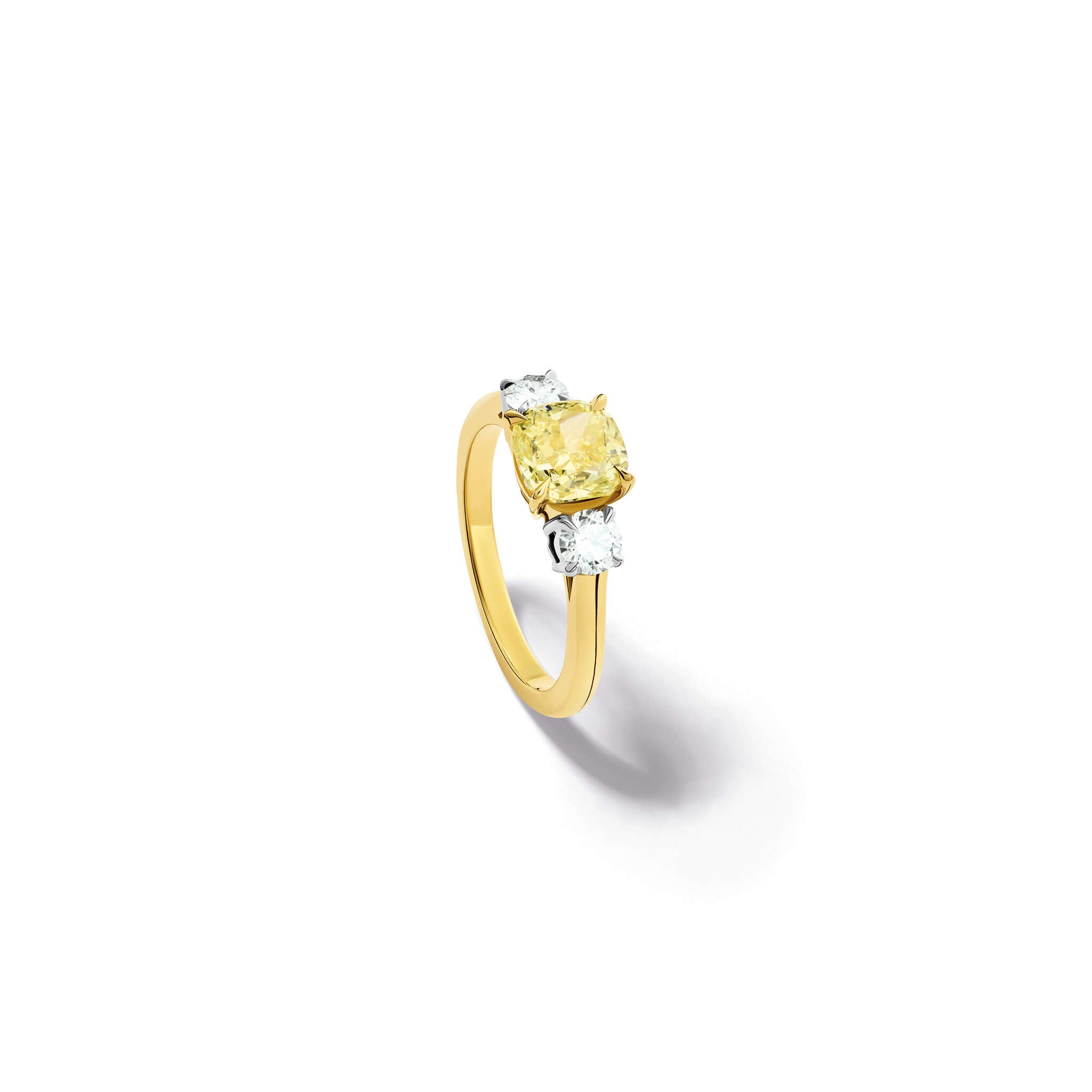 Handcrafted yellow gold yellow diamond engagement ring with two diamonds set in white gold on each side