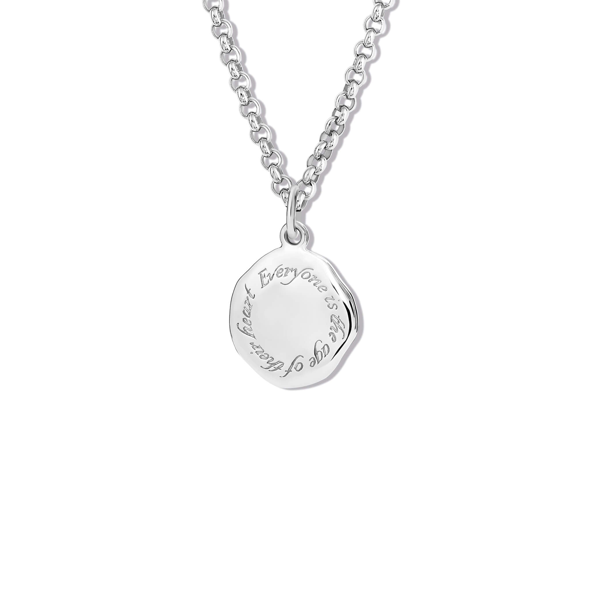 Handcrafted round silver necklace pendant engraved with the quote, 'Everyone is the age of their heart.'