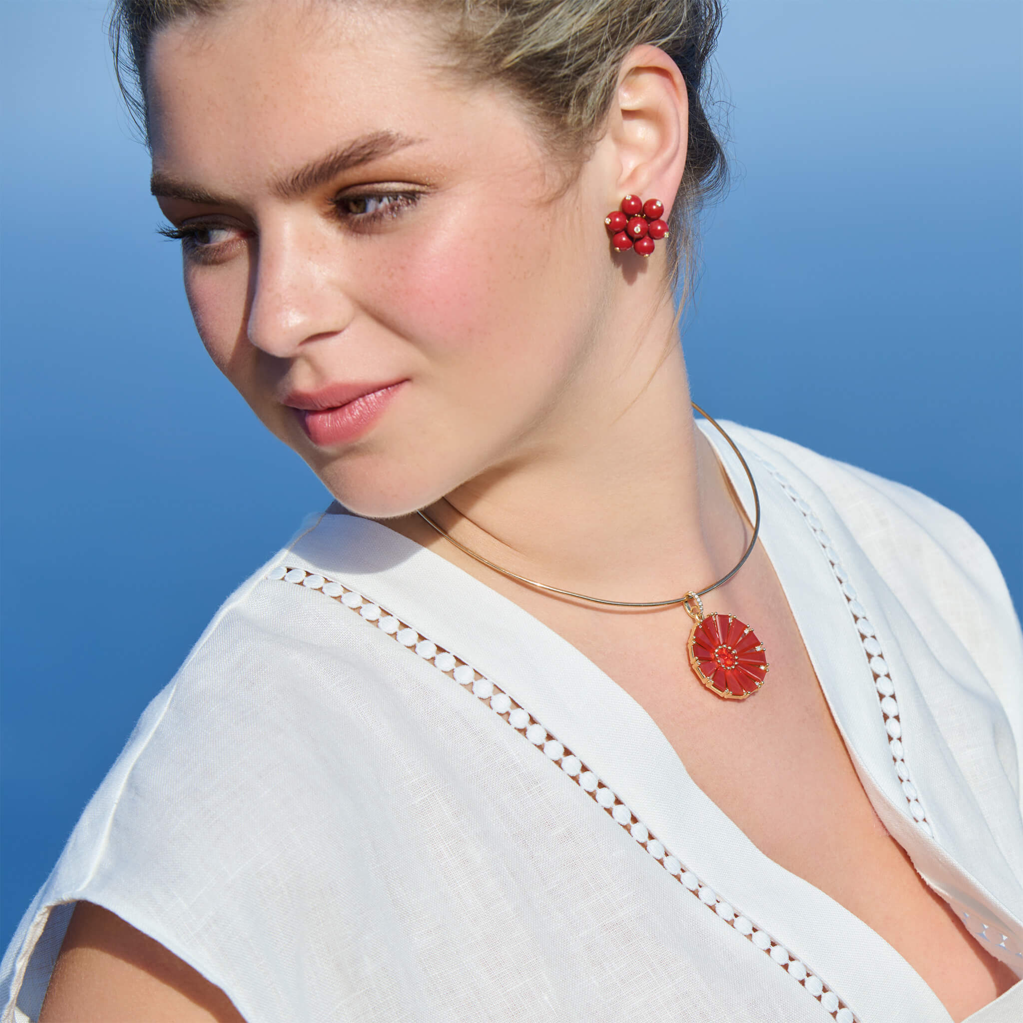 Model wearing handcrafted necklace pendant and earrings inspired from countries around the world 