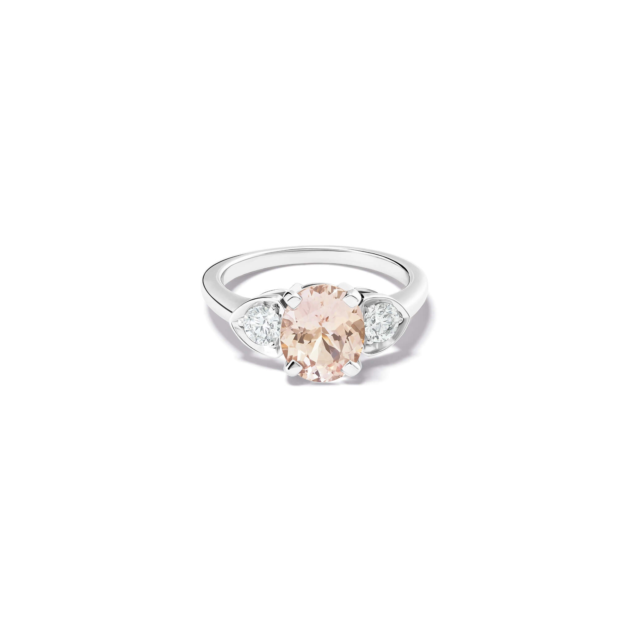 Handcrafted 18ct white gold engagement ring featuring a large central oval light pink sapphire flanked by one smaller teardrop-shaped diamond on each side.