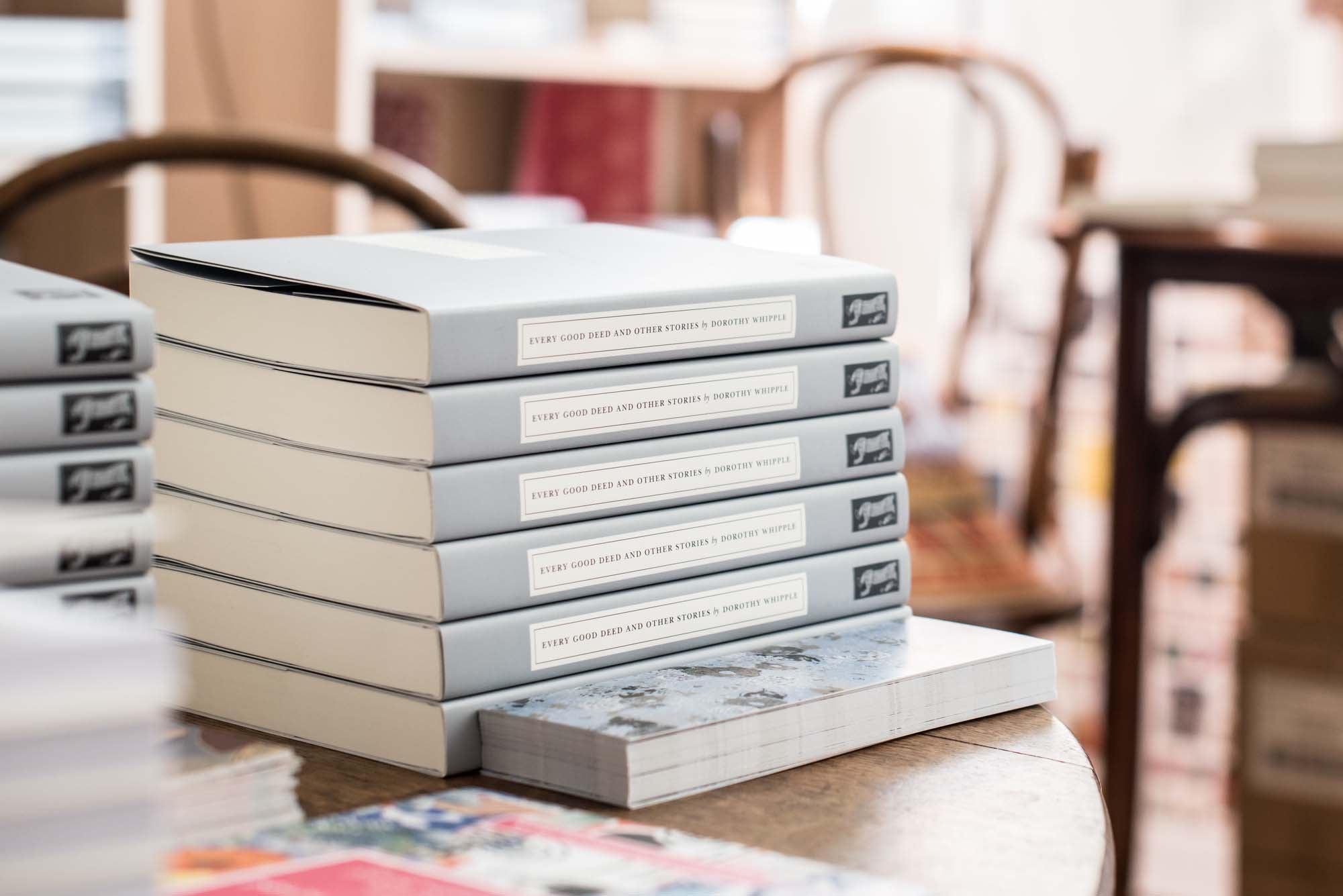 Pile of six Persephone Books with their classic grey cover. 