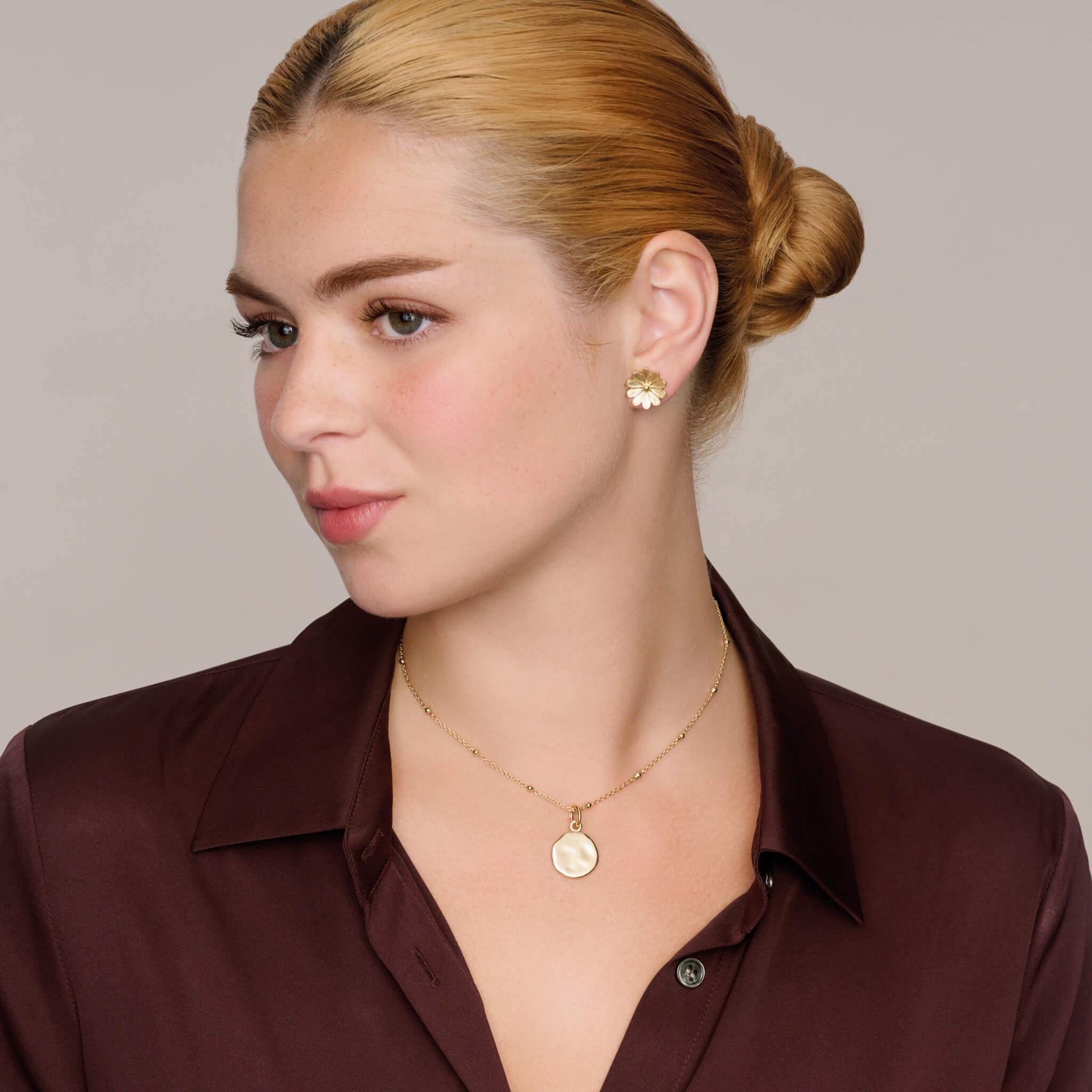 model wears engravable precious metal pebble disc small pendant for personalised jewellery, from cassandra goad's classic collection