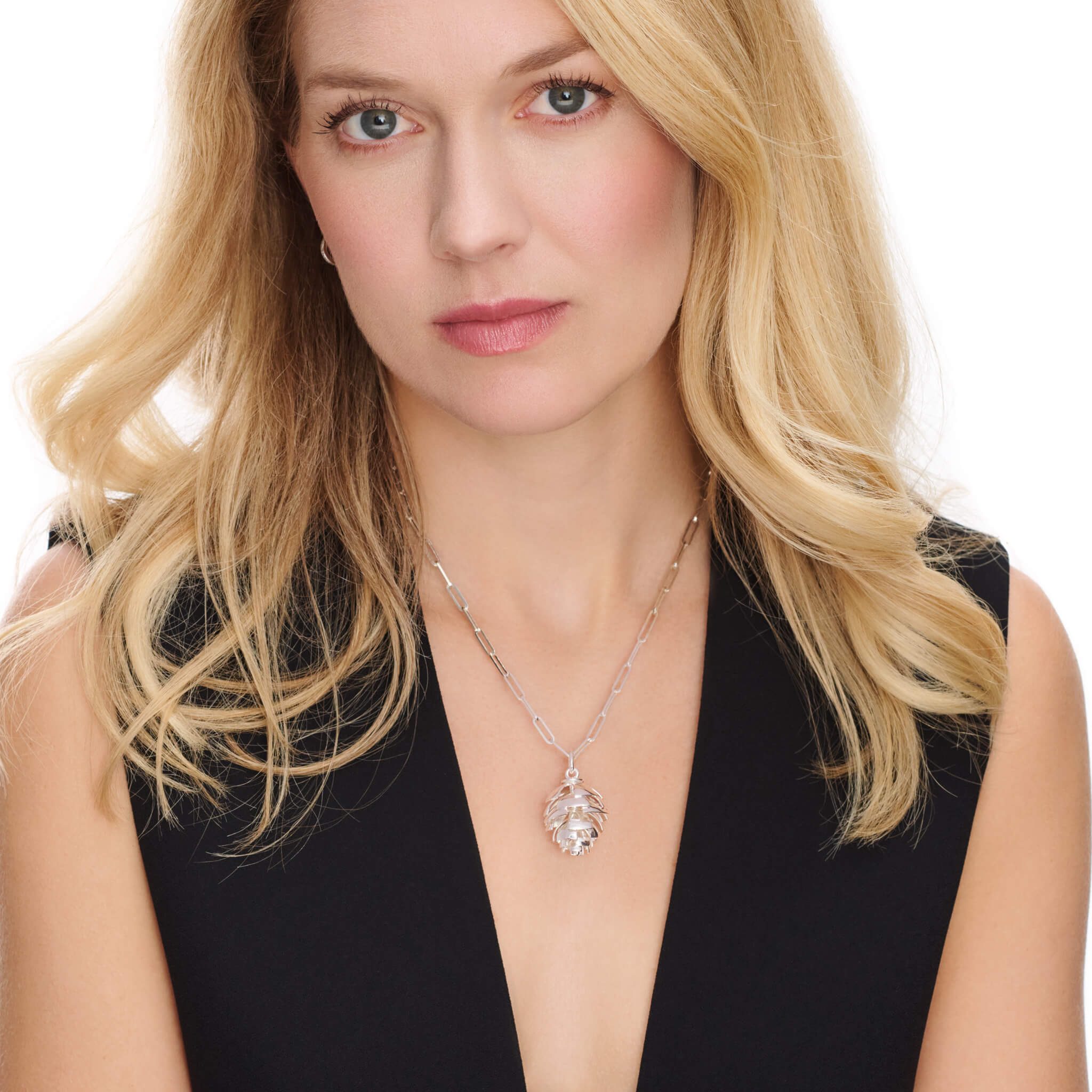 Model wearing a handcrafted sterling silver fir cone shaped necklace pendant 