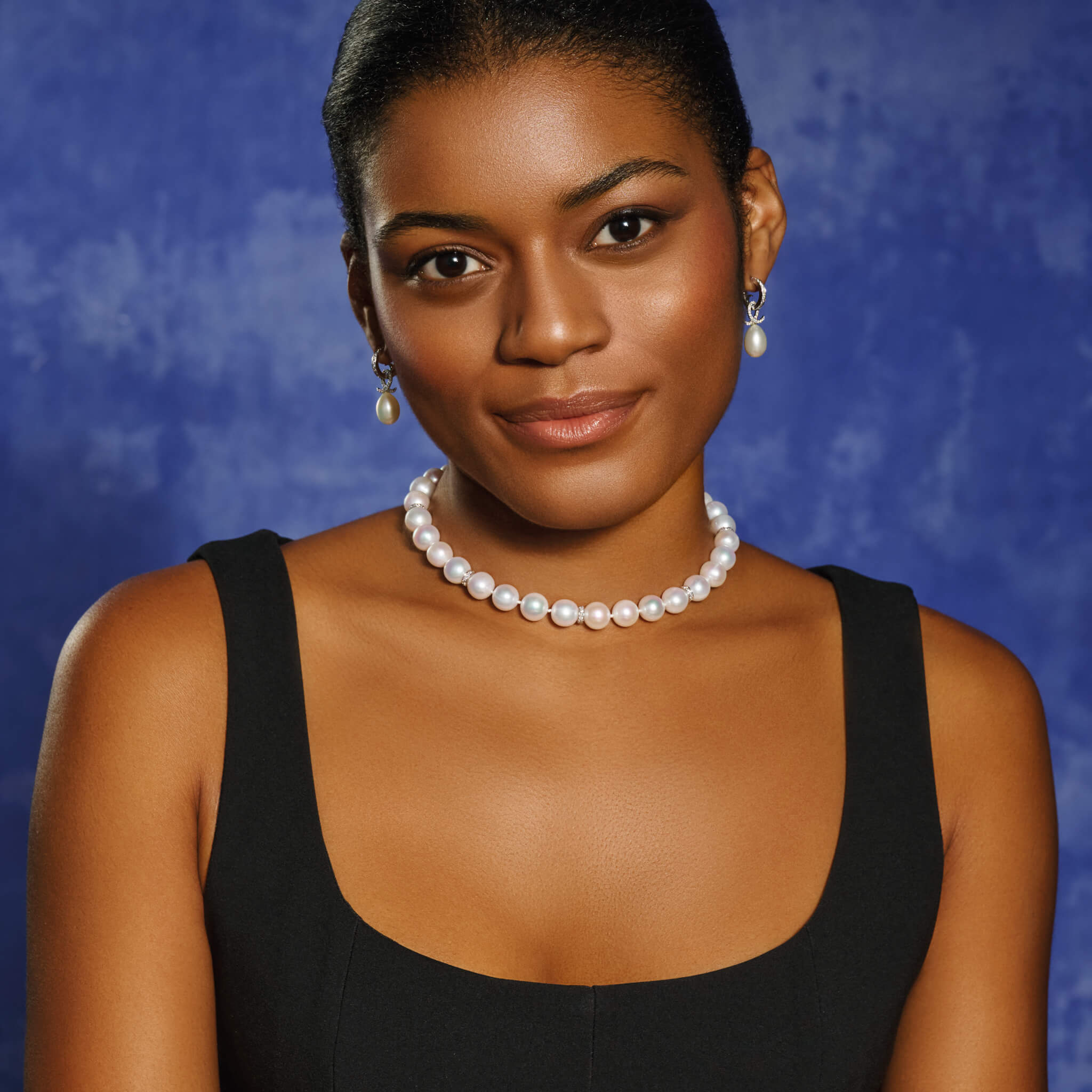 Model wears handcrafted freshwater pearl necklace with 18ct white gold and diamond spacers.