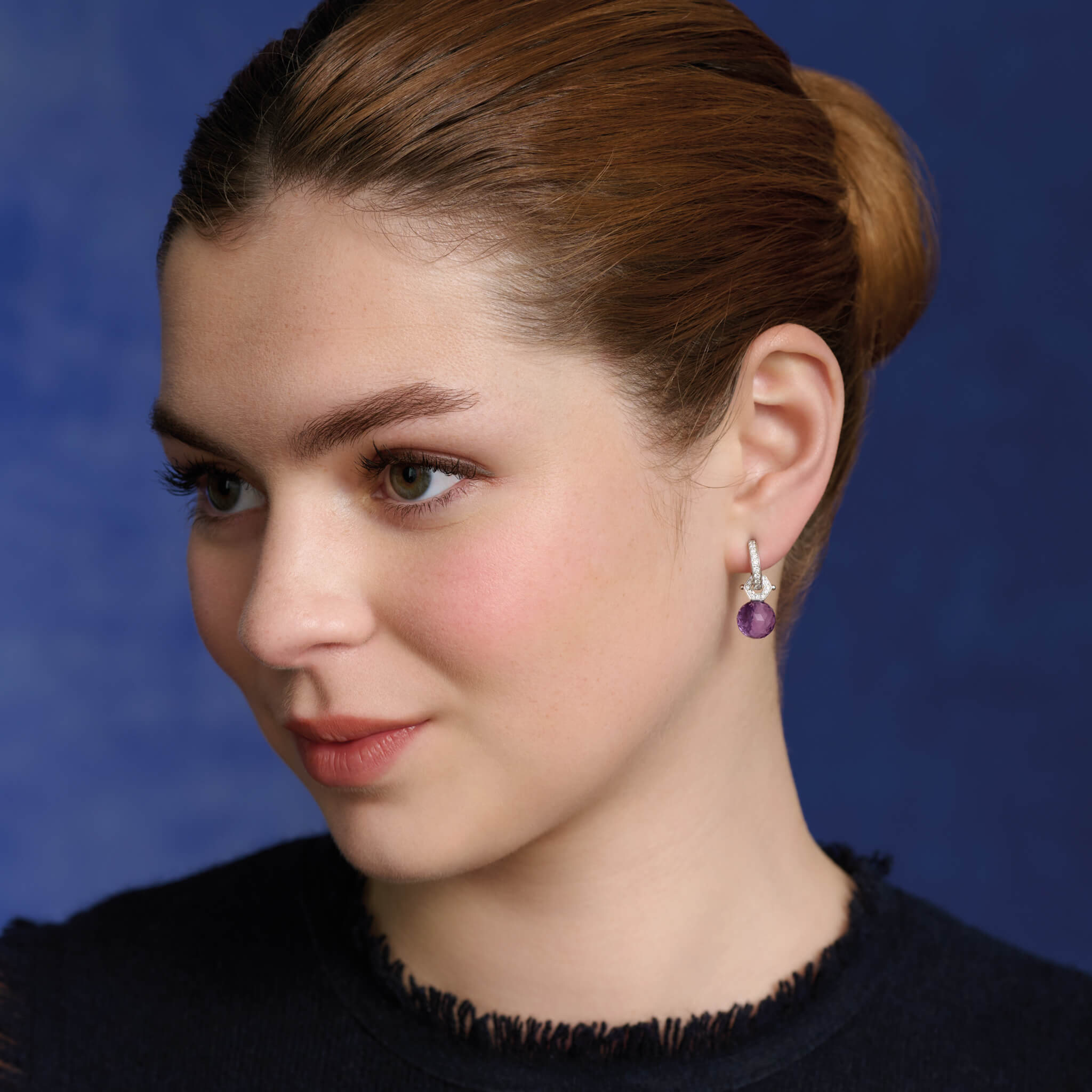 Model wears handcrafted Melissae di Erice earring pendant in 18ct white gold and 18ct yellow gold, with facetted round briolette amethyst on diamond pavé fitting.